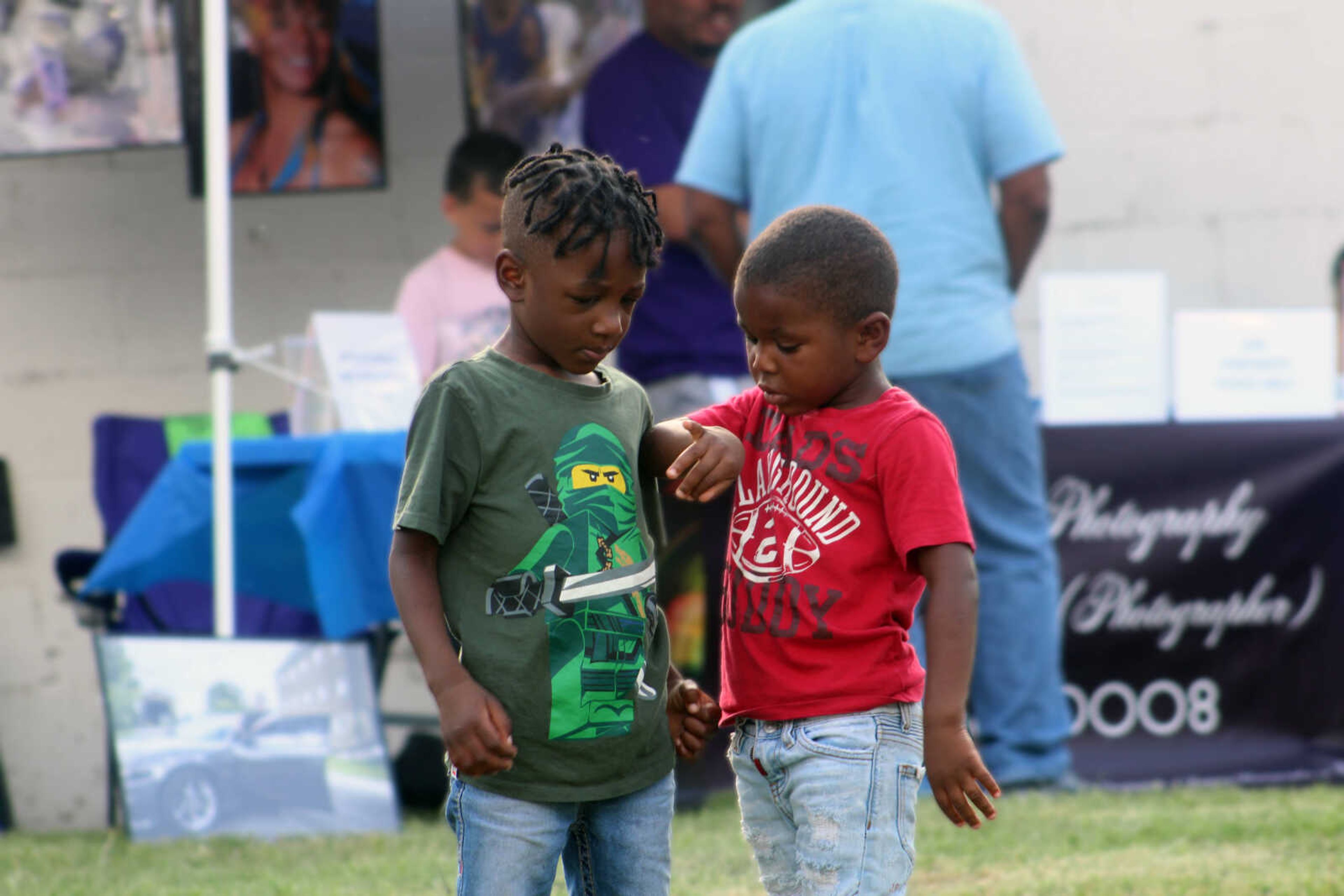 Marion Moore and Messiah Winston play together during One City's second annual Juneteenth Celebration on Saturday, June 19, 2021, in the parking lot of One City in Cape Girardeau.