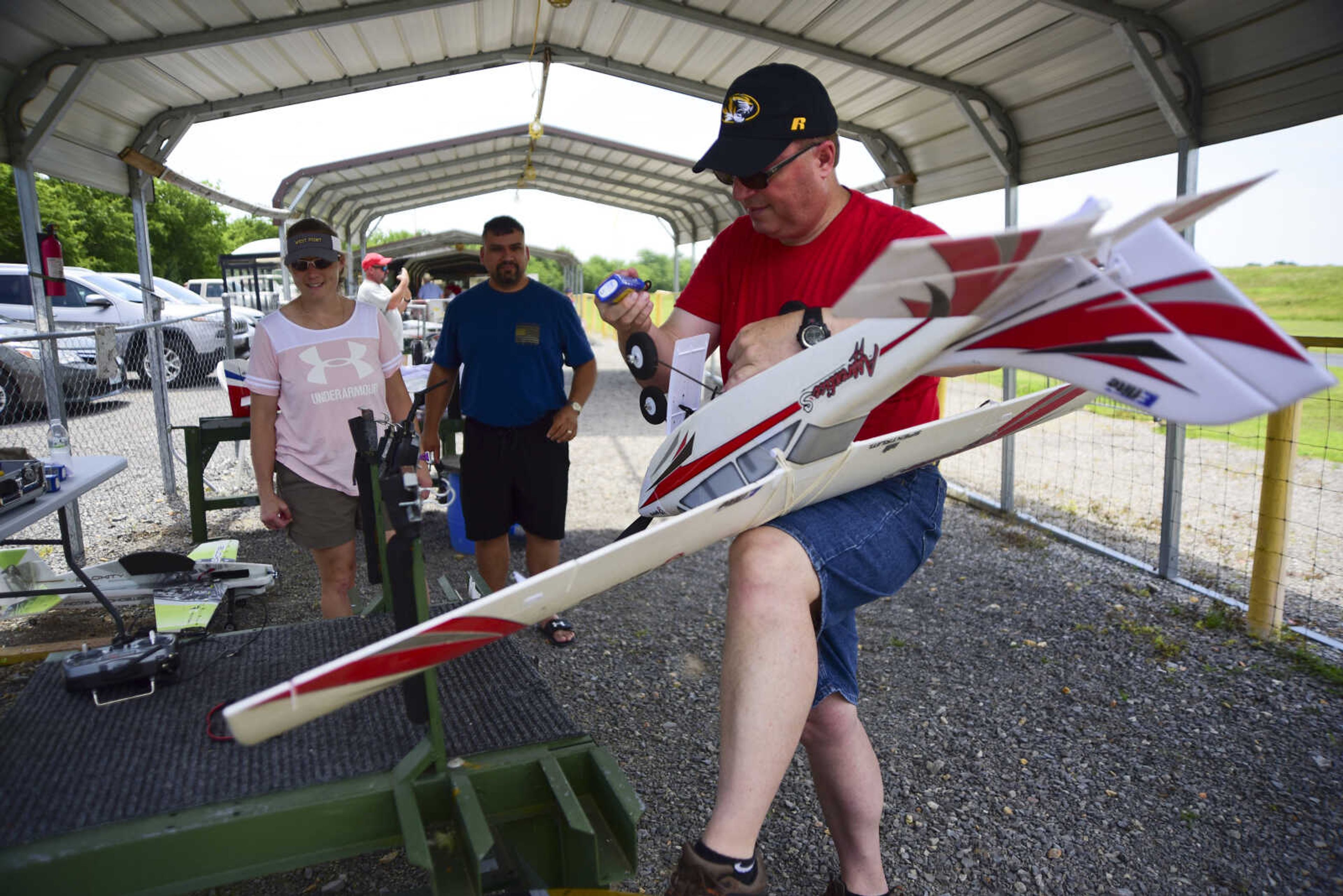 Mark McCoy prepares his airplane for the Cape Fly Hi radio controlled aircraft demonstration Saturday, June 3, 2017 at Galaxy Park in Cape Girardeau.