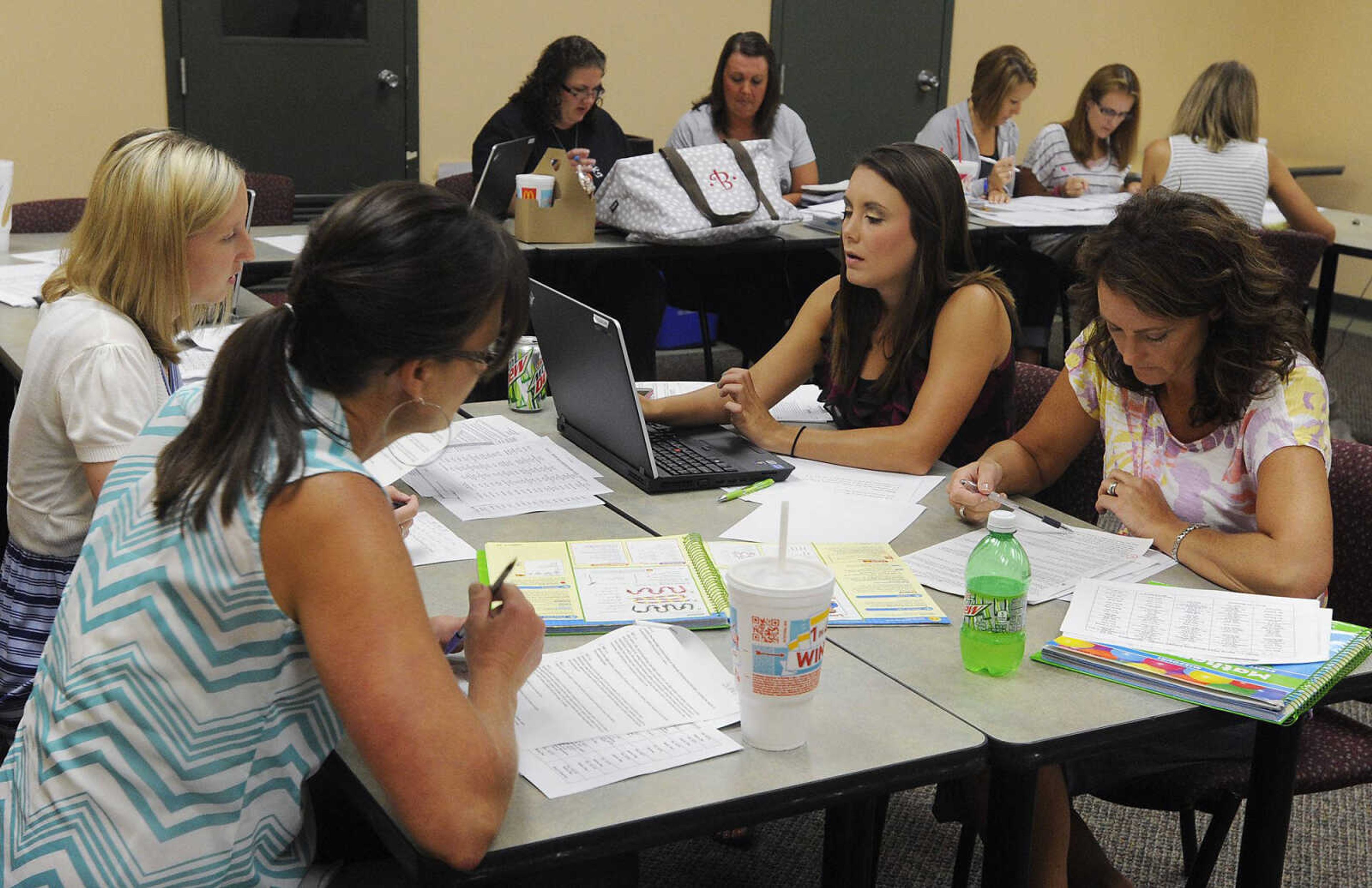 First grade teachers Ashley Kelley, left, Jennie McCord, Whitney Carter and Gretchen Bunch discuss plans for the coming years curriculum Wednesday, July 17, at the Cape Girardeau School District Office. Cape Girardeau schools are transitioning towards full implementation of the Common Core State Standards , which is planned for the 2014 school year. (Adam Vogler)