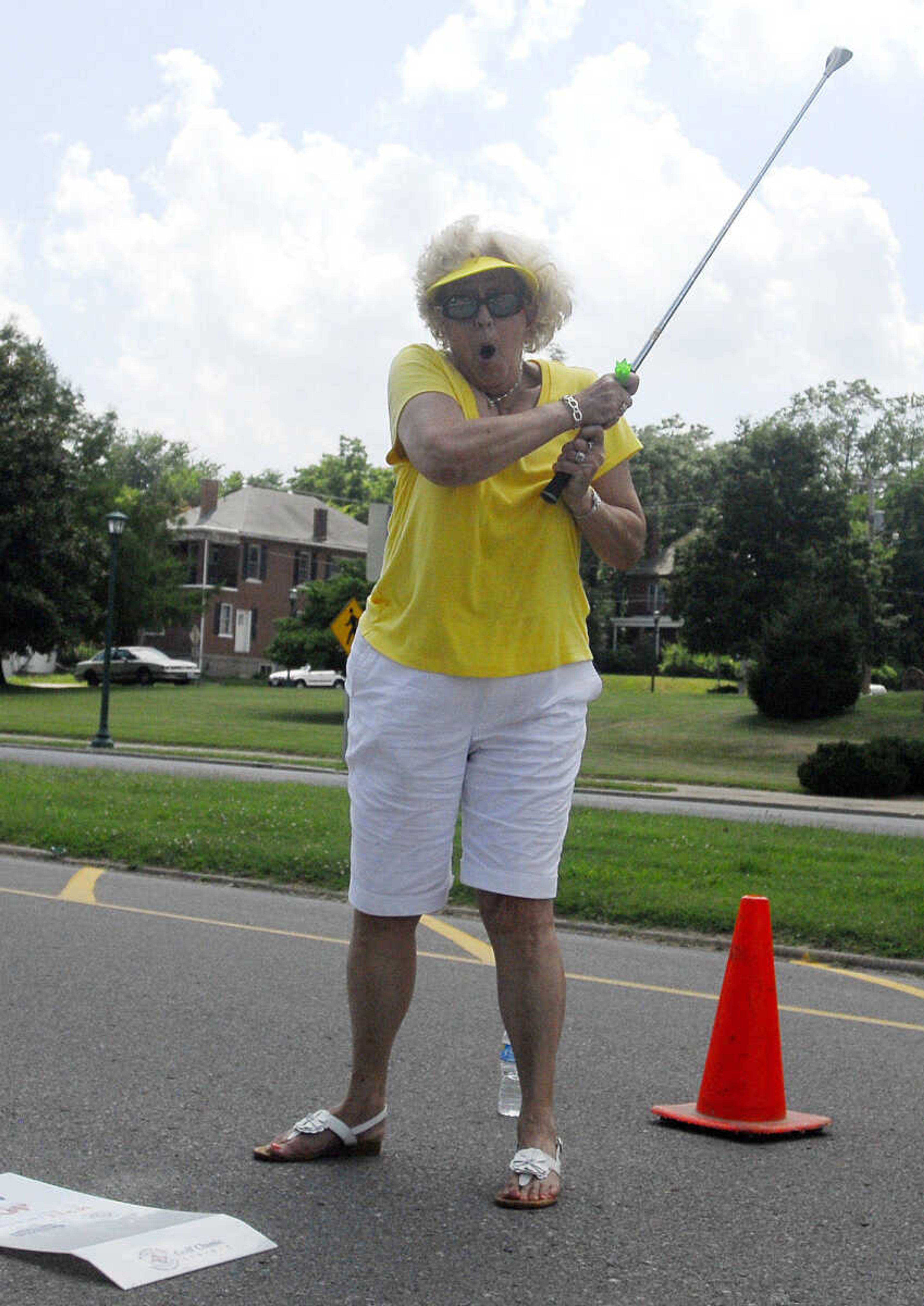 LAURA SIMON~lsimon@semissourian.com
Judy Herbst reacts after hitting the photographer with the BirdieBall as she tees off Sunday, June 27, 2010 during the First-Ever Fifth Annual Louis J. Lorimier World Famous Downtown Golf Tournament in Cape Girardeau.