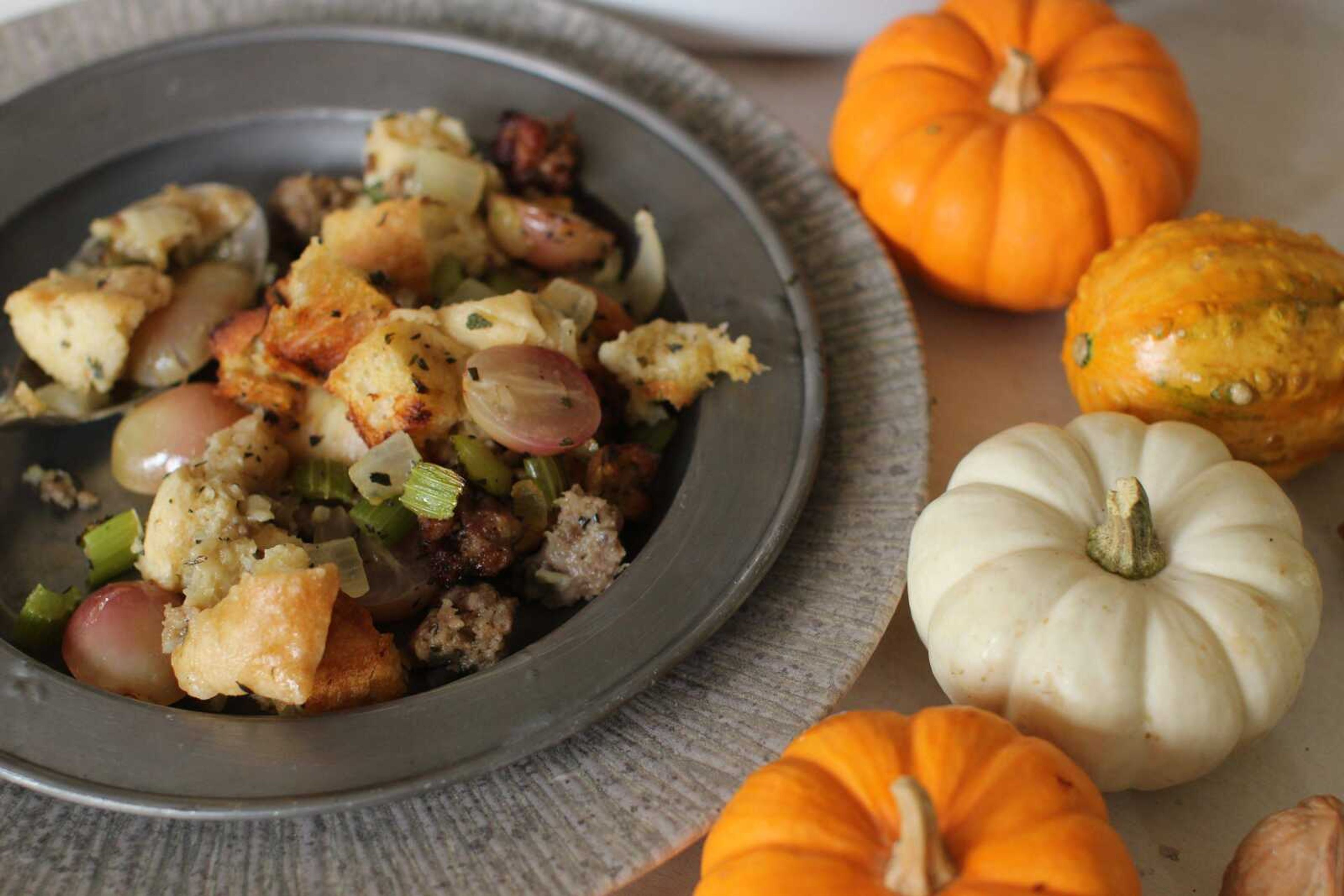 This photo shows sausage and grape Thanksgiving stuffing. Making one giant batch of stuffing allows for some of it to be used to stuff the turkey, while the rest can be put into a well-buttered baking dish. (AP Photo/Matthew Mead)