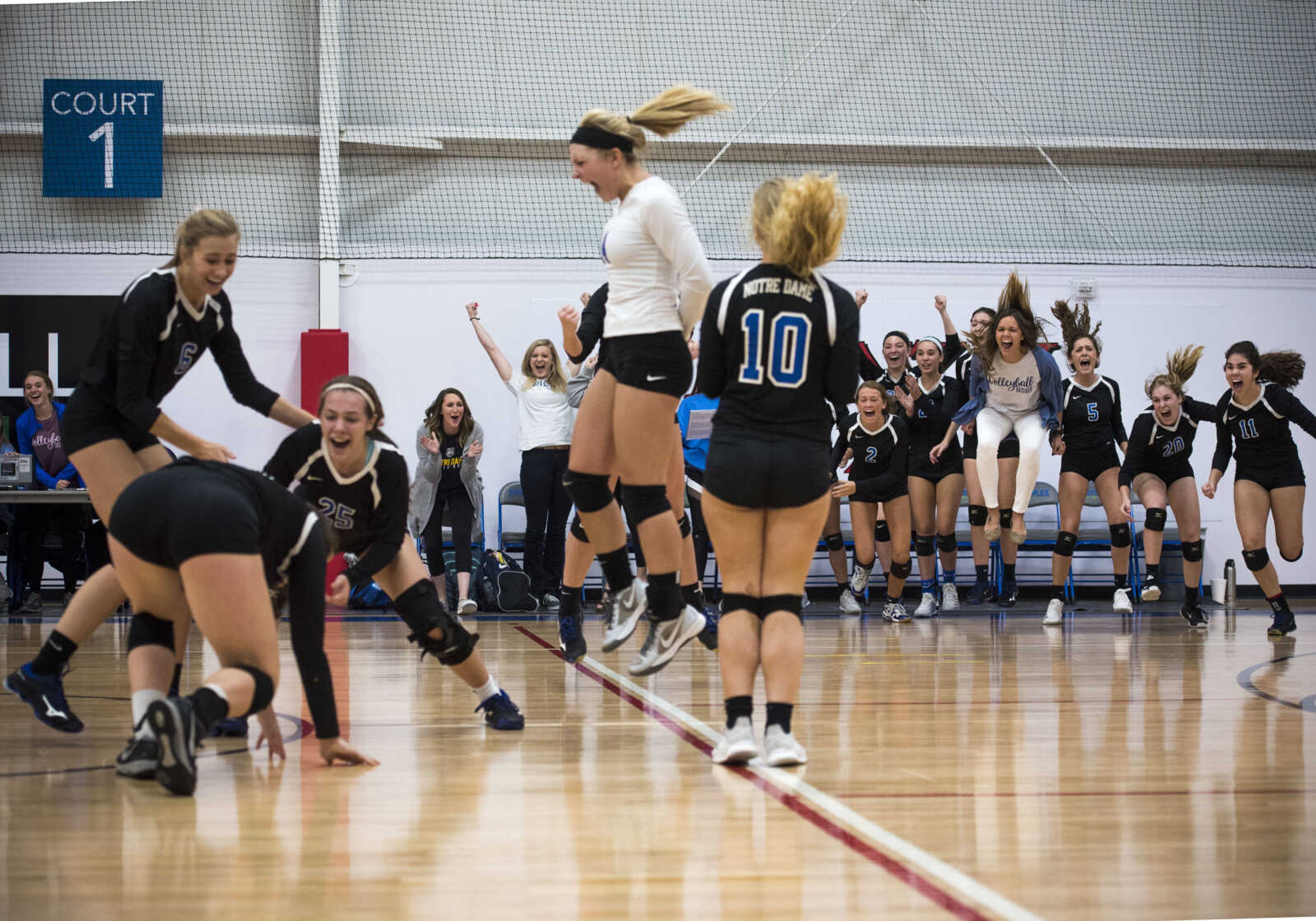 The Notre Dame bench erupts as players on the court celebrate scoring the game winning point during in the second set of the conference championship against Jackson on Thursday, Oct. 18, 2018, at the Cape Girardeau SportsPlex.