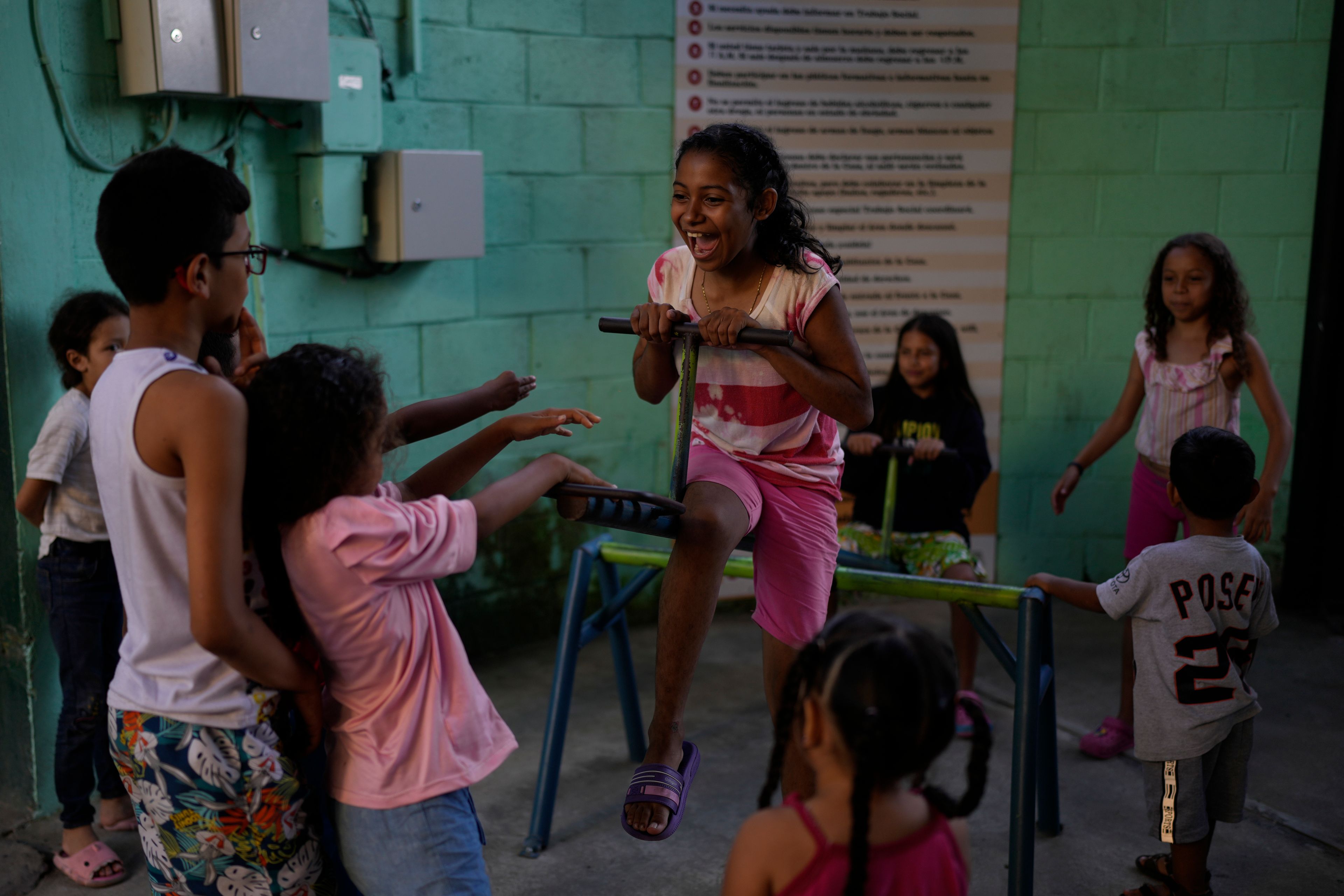 Venezuelan migrant Kelly Veloz, center, plays with other children at the Casa del Migrante shelter in Tecun Uman, Guatemala, Sunday, Oct. 27, 2024. (AP Photo/Matias Delacroix)