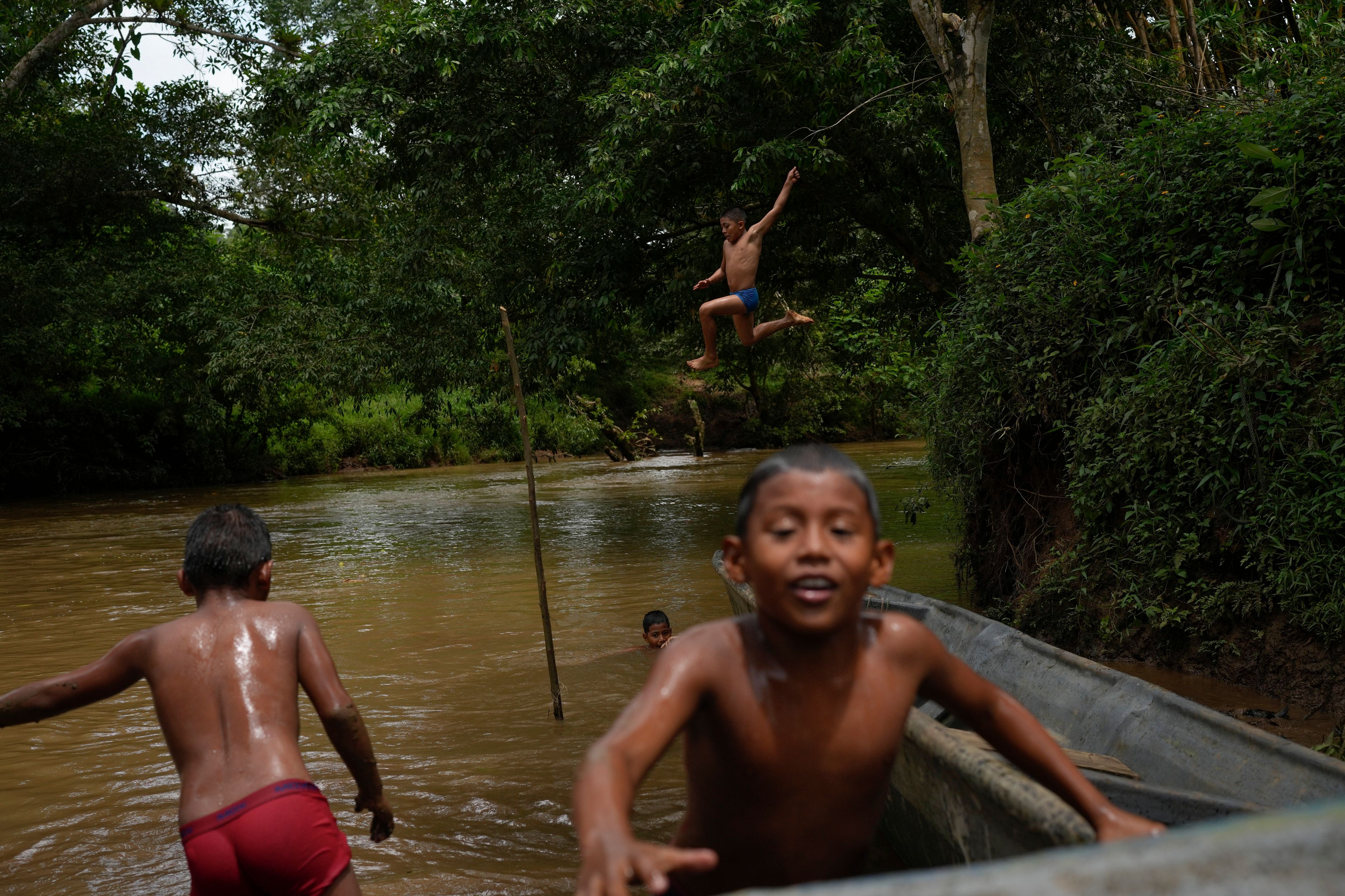 Children in El Jobo village play in the Indio River, which could have its flow reduced under a proposed plan to secure the Panama Canal’s uninterrupted operation in Panama, Saturday, Aug. 31, 2024. (AP Photo/Matias Delacroix)