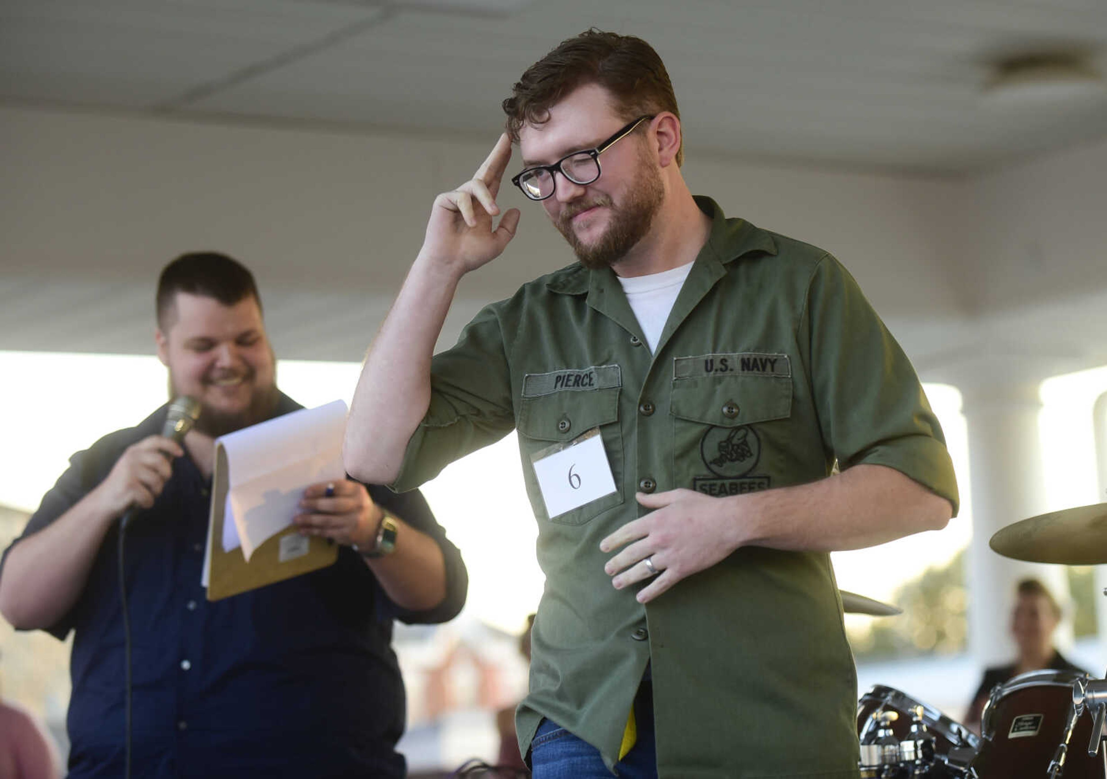 Trevor Camp salutes the audience after the beard contest during the Perryville Pinup contest Saturday, Sept. 2, 2017 in downtown Perryville.