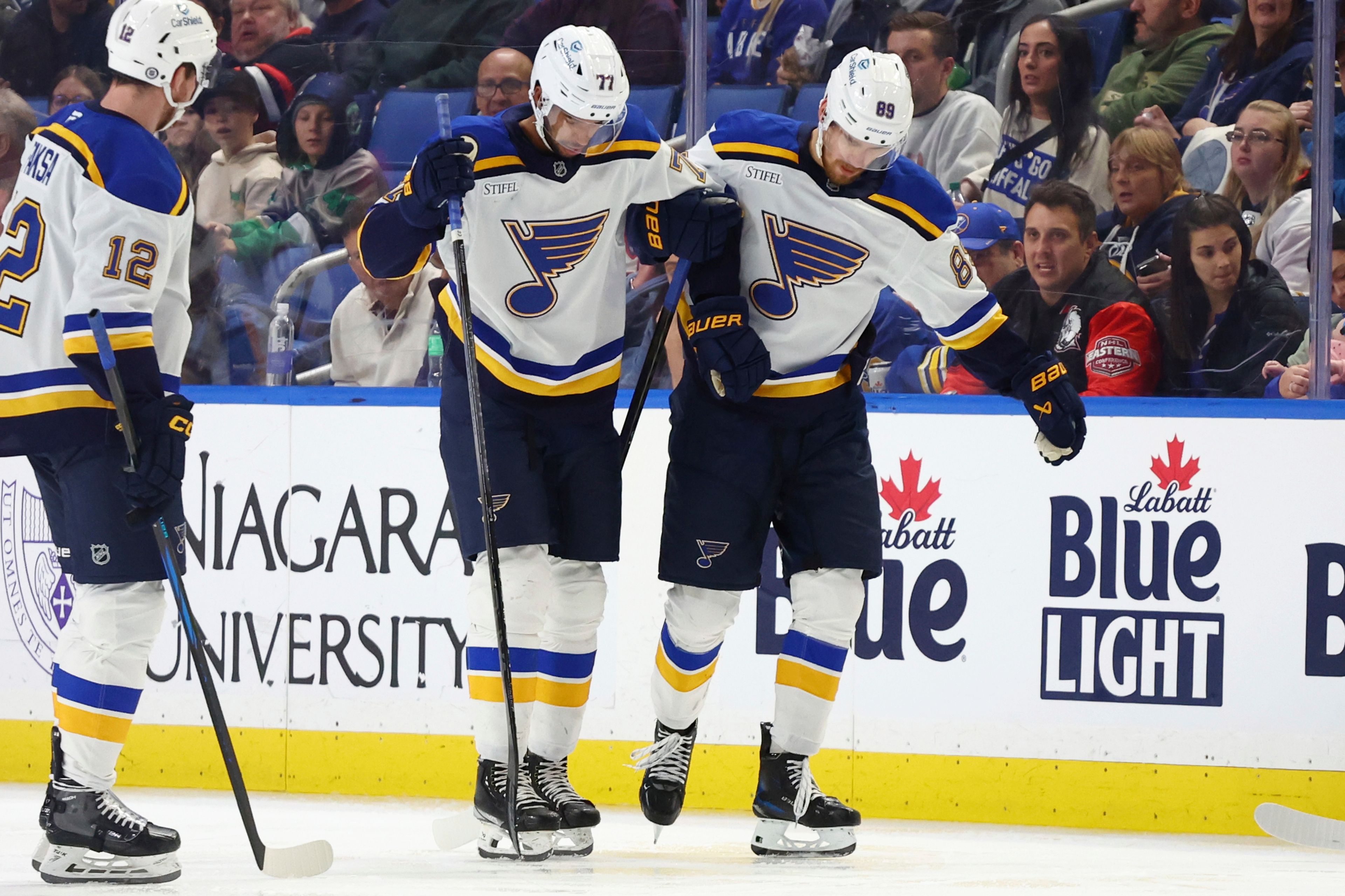 St. Louis Blues defenseman Pierre-Olivier Joseph (77) is helped off the ice by teammate Pavel Buchnevich (89) during the second period of an NHL hockey game against the Buffalo Sabres, Thursday, Nov. 14, 2024, in Buffalo, N.Y. (AP Photo/Jeffrey T. Barnes)