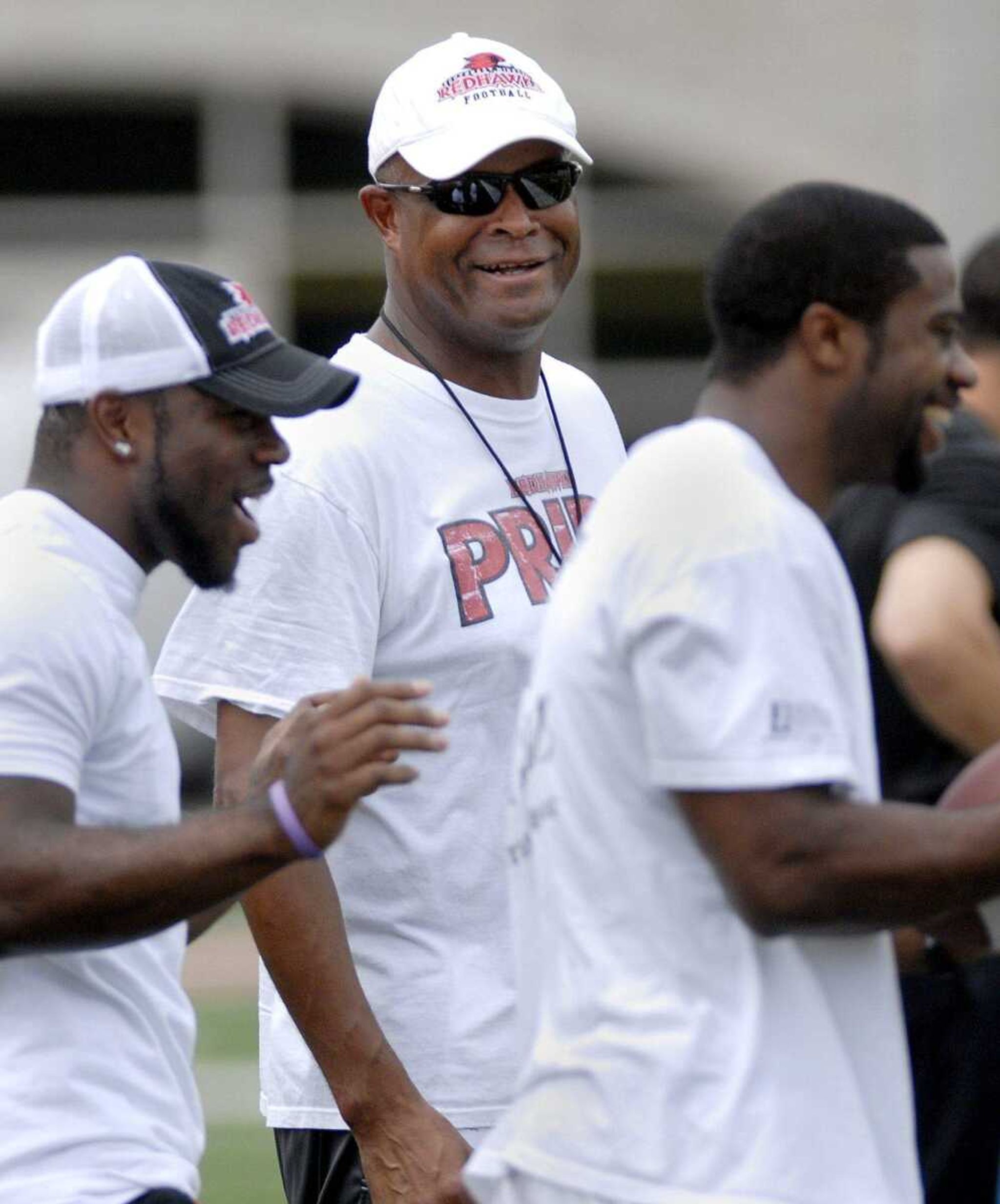 Southeast Missouri State University head football coach Tony Samuel shares a laugh Saturday, August 20, 2011 during the Redhawks football scrimmage at Houck Stadium. (Laura Simon)