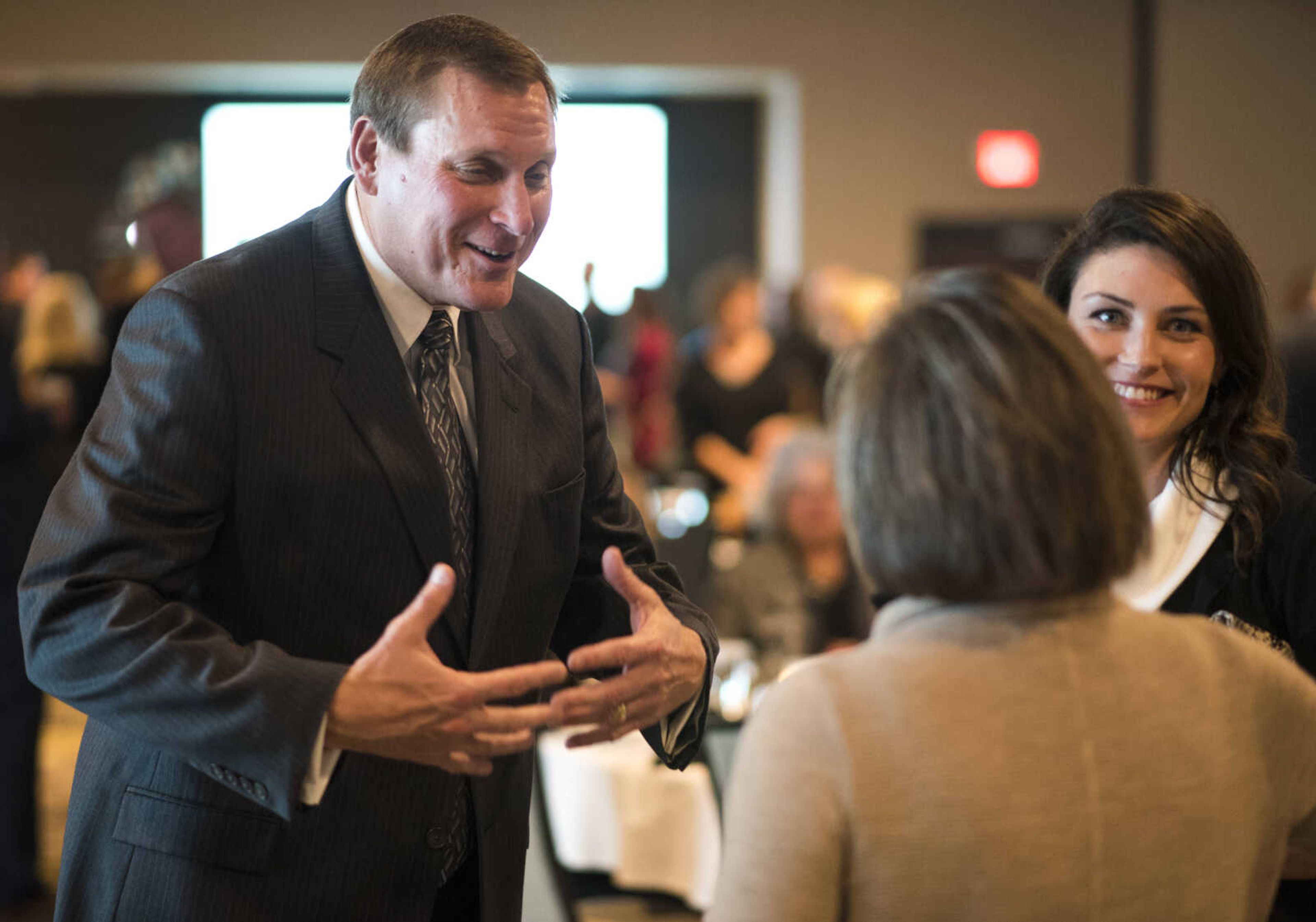 Rush H. Limbaugh Award recipient Bob Neff talks to Monica Waldon, right, and Patty Harrell, far right, at the Cape Girardeau Area Chamber of Commerce's annual dinner held Jan. 26, 2018, at the Drury Plaza Conference Center in Cape Girardeau.