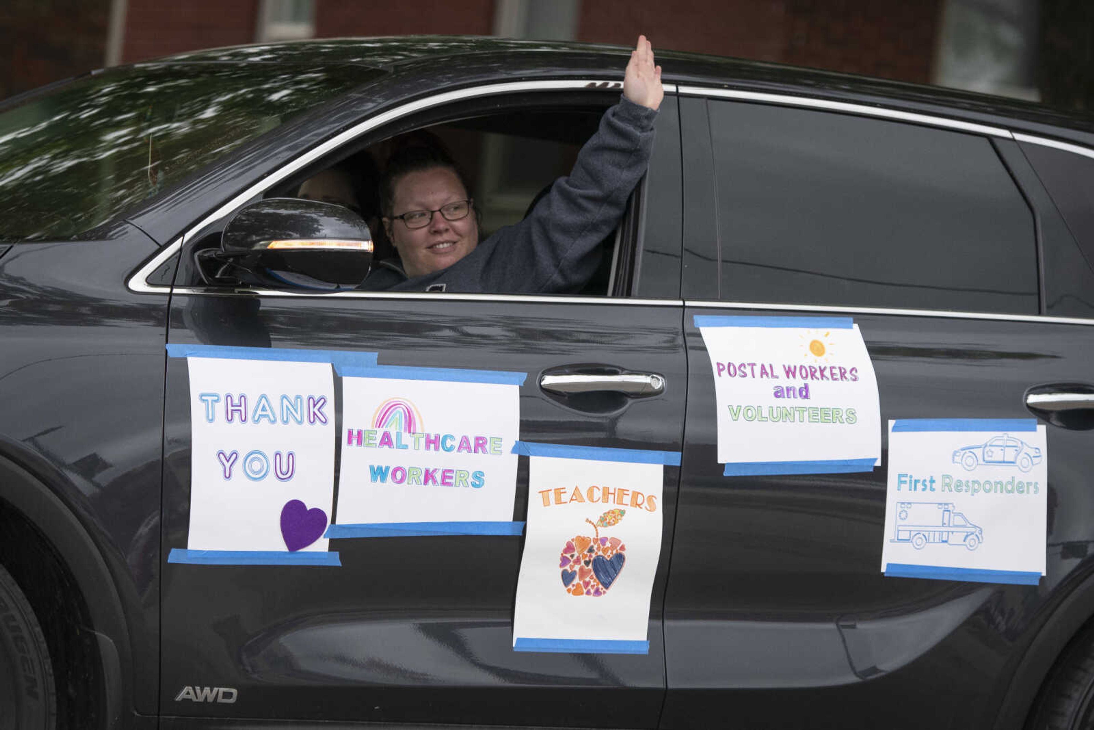 Laci Poole of Cape Girardeau, with CASA (Court Appointed Special Advocate), waves while driving past Franklin Elementary School during the United Way of Southeast Missouri's #GiveUnitedCarParade on Tuesday, May 5, 2020, in Cape Girardeau.