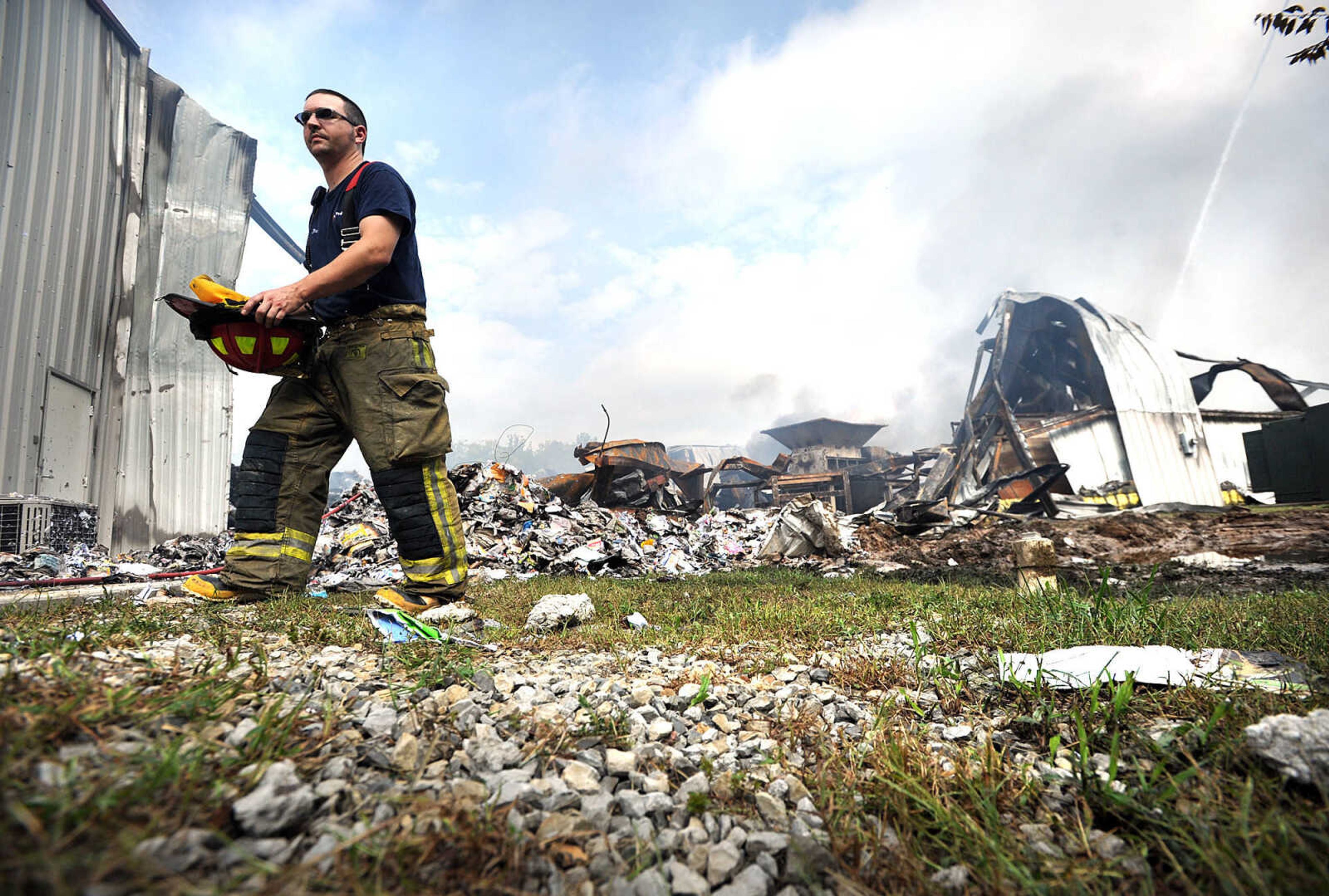 LAURA SIMON ~ lsimon@semissourian.com

Josh Boyd with the East County Fire Protection District takes a break from battling hot spots at the Missouri Plastics plant Friday morning, Oct. 4, 2013, in Jackson. The approximately 100,00-square-foot recycling plant caught fire around 10 p.m. Thursday. Every fire department in Cape Girardeau County was dispatched to battle the blaze.