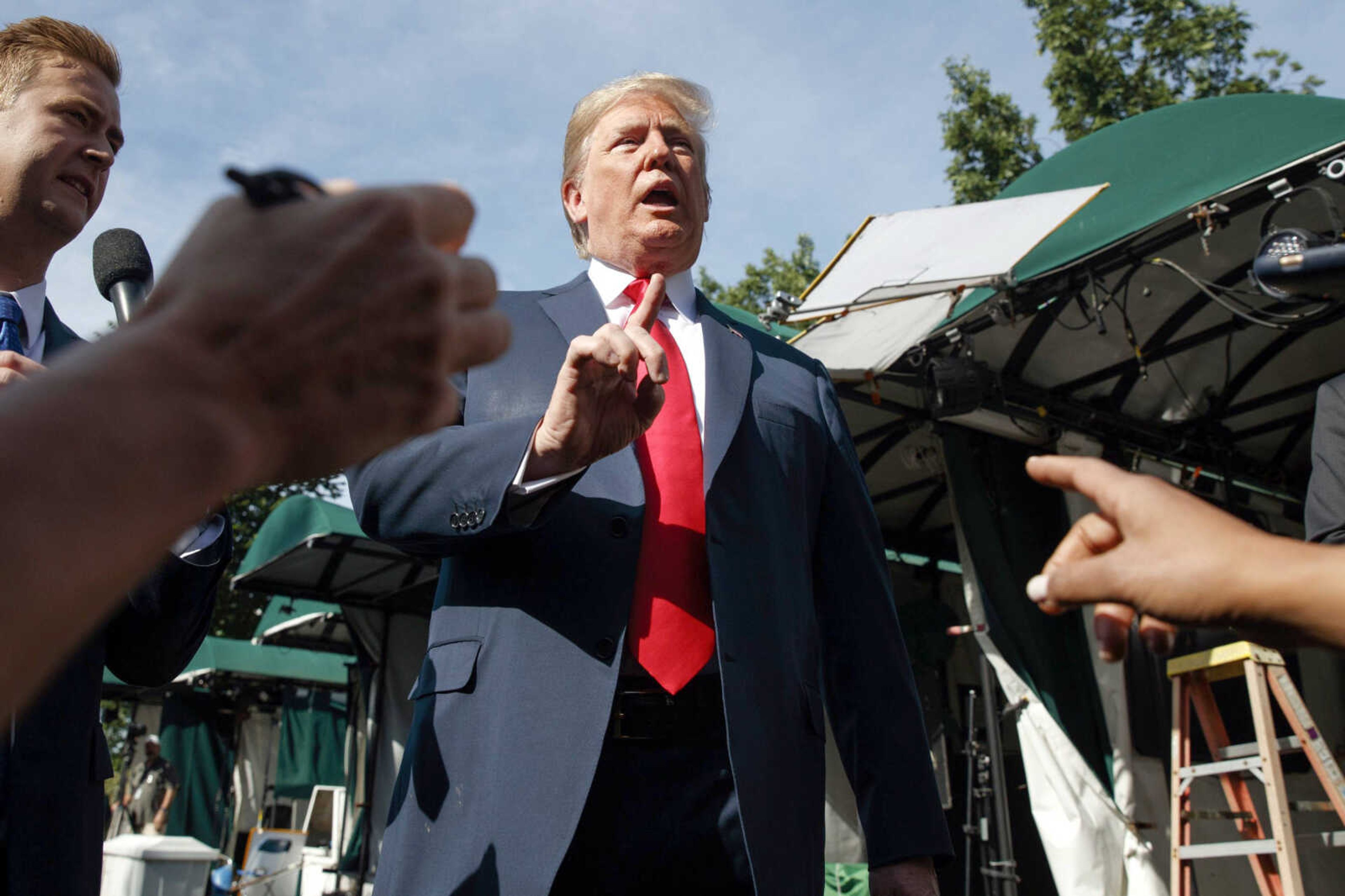 President Donald Trump speaks to reporters Friday on the North Lawn of the White House in Washington.