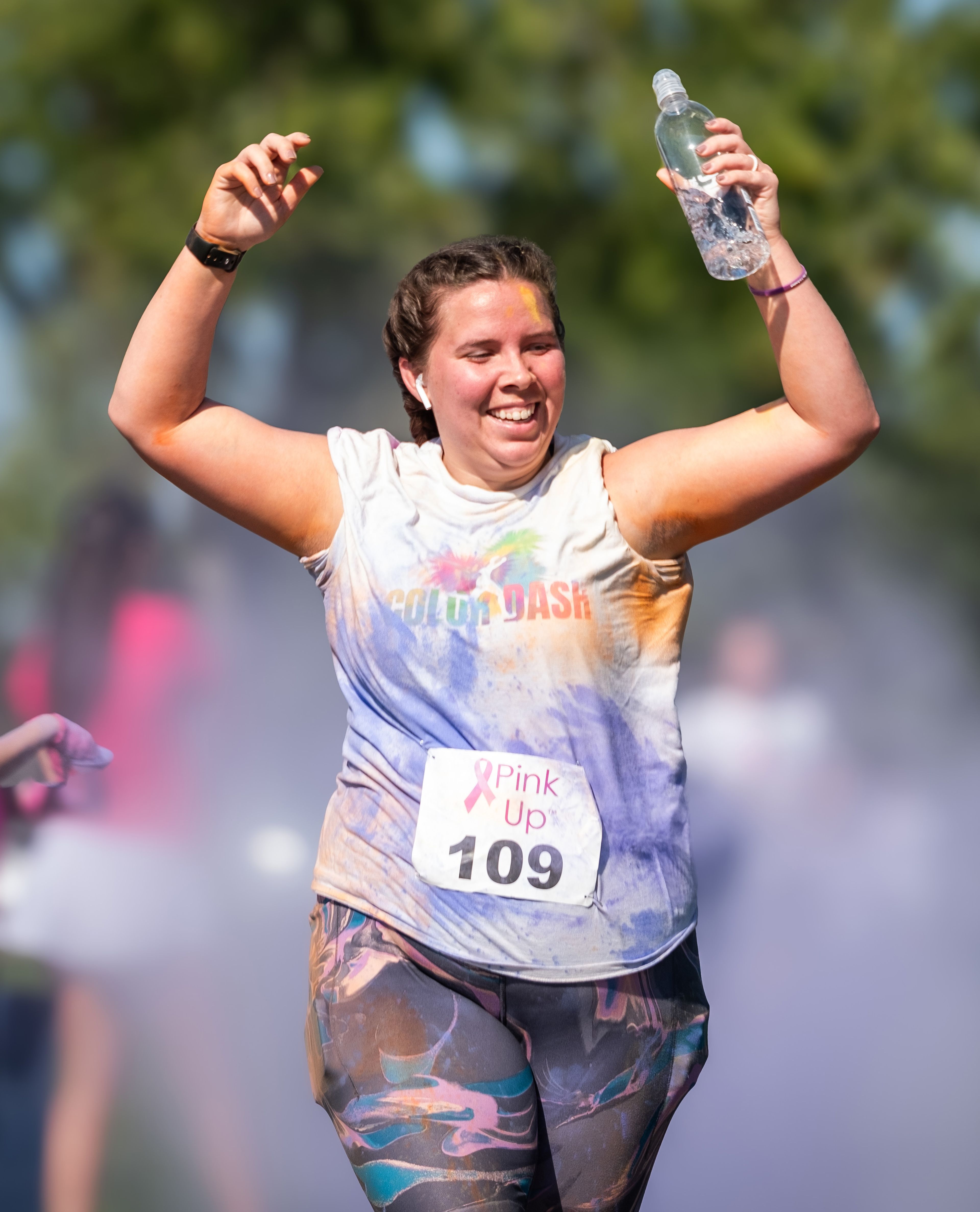 Makayla Kindle of Cape Girardeau cheers enthusiastically as volunteers toss brightly colored chalk during the race.
