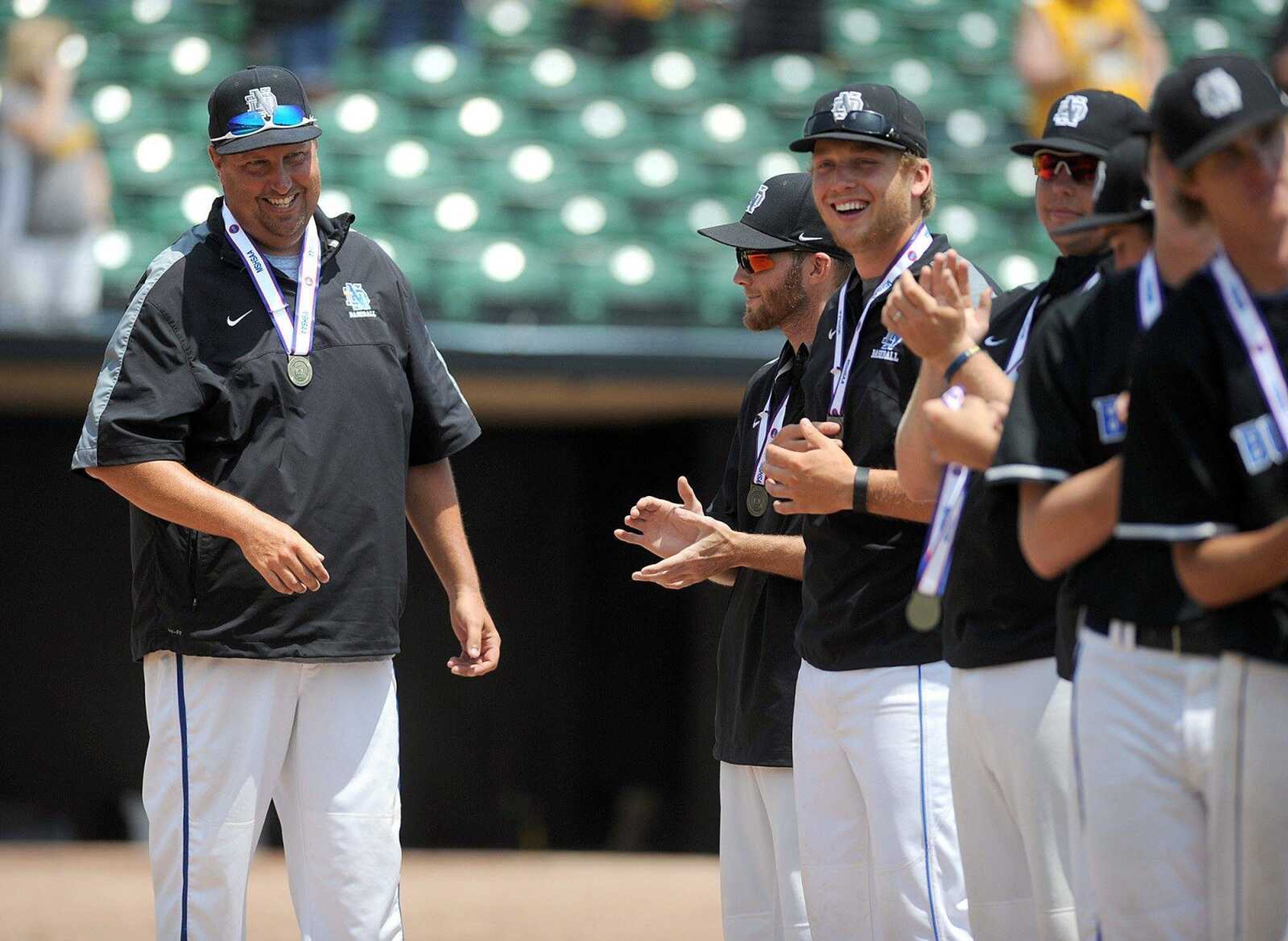 Notre Dame head coach Jeff Graviett beams as his players receive their medals after the Bulldogs 17-0 Class 4 championship win over Sullivan, Saturday, June 6, 2015, in O Fallon, Missouri. (Laura Simon)