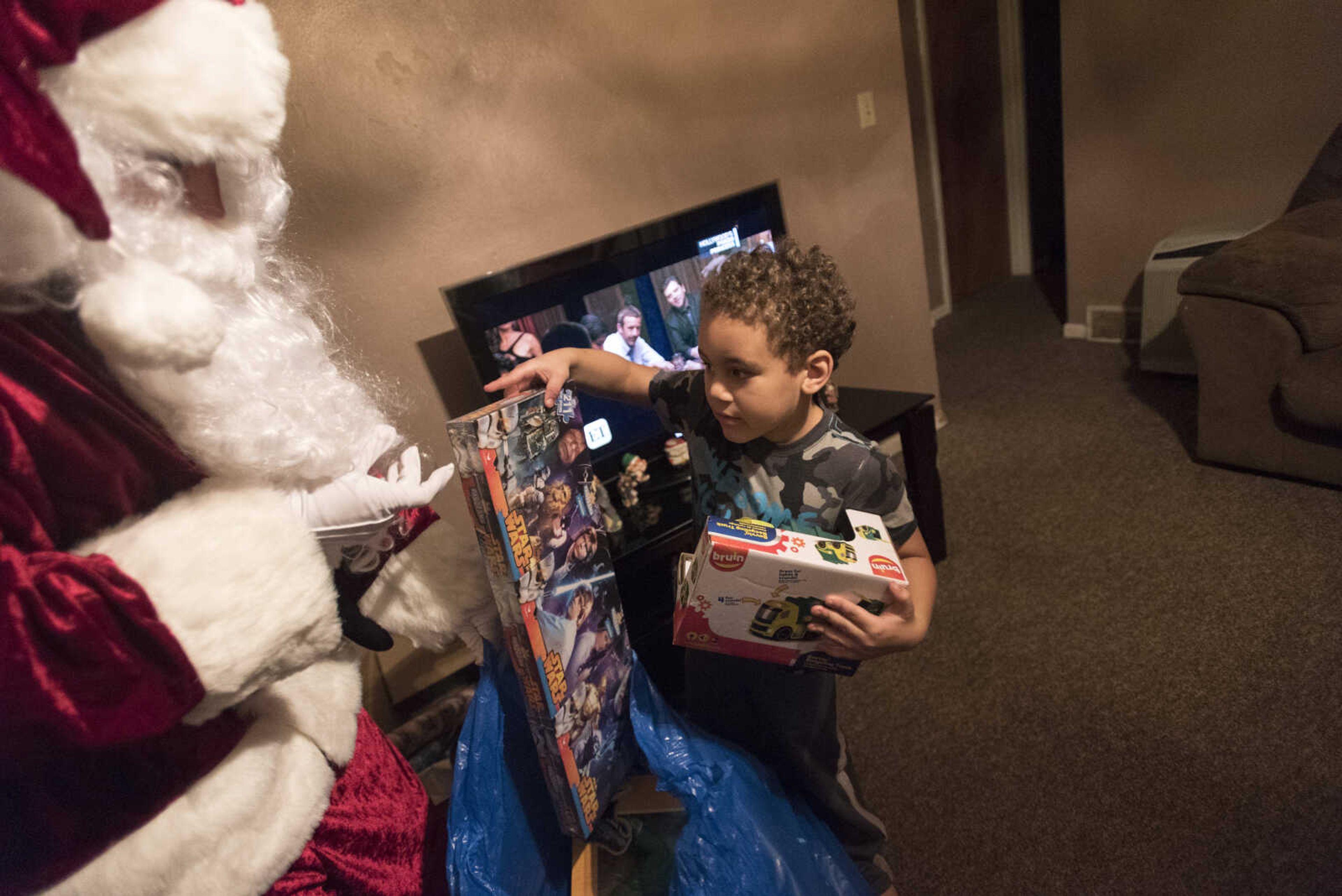 Charlie Wirtle as Santa deliveries presents to kids during the Jaycee Toybox delivery on Thursday, Dec. 22, 2016, in Cape Girardeau.