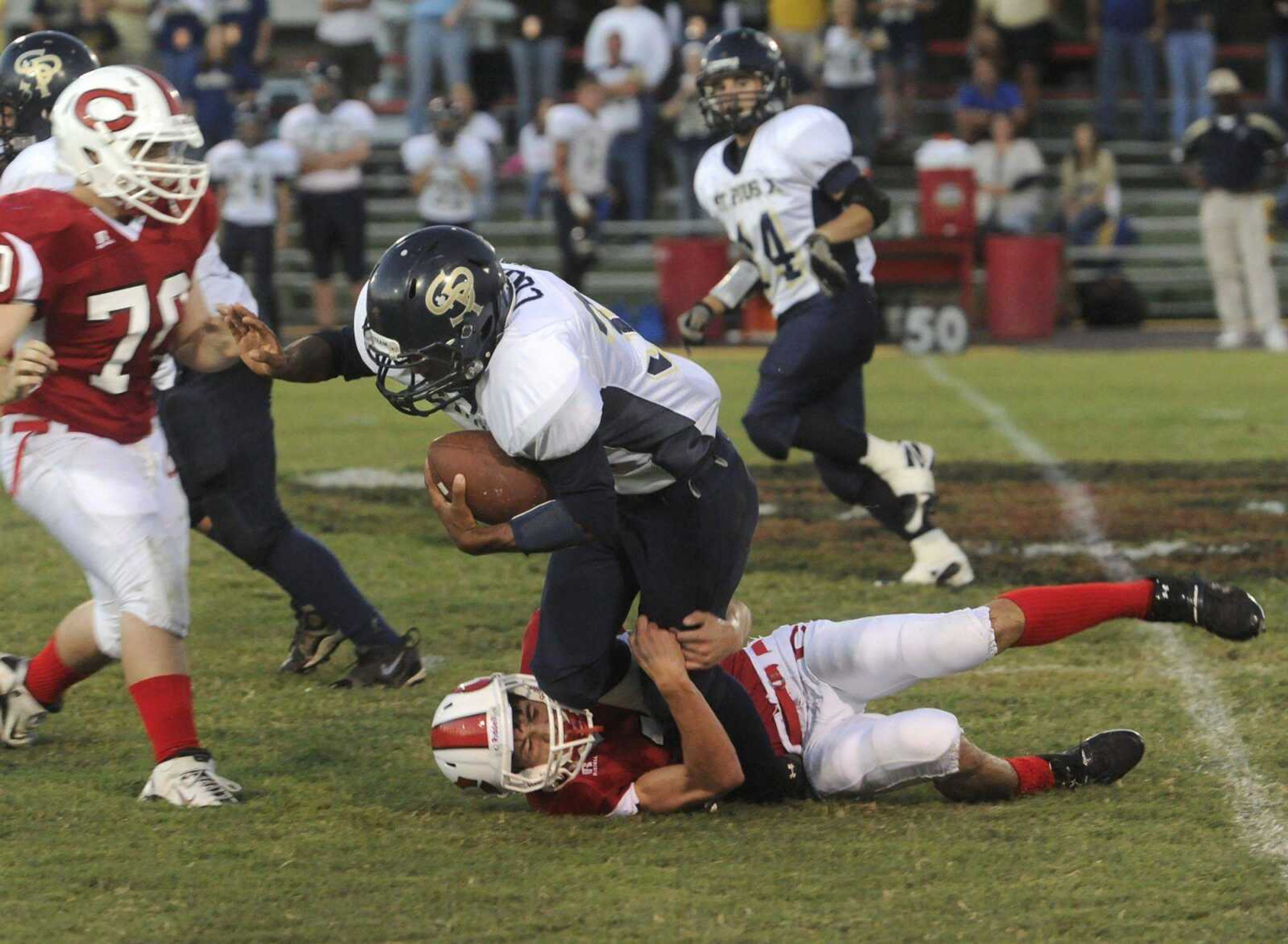 St. Pius' Talon Cook is brought down by Chaffee's Jason Cicardi during the first quarter Friday at Chaffee High School. (Fred Lynch)