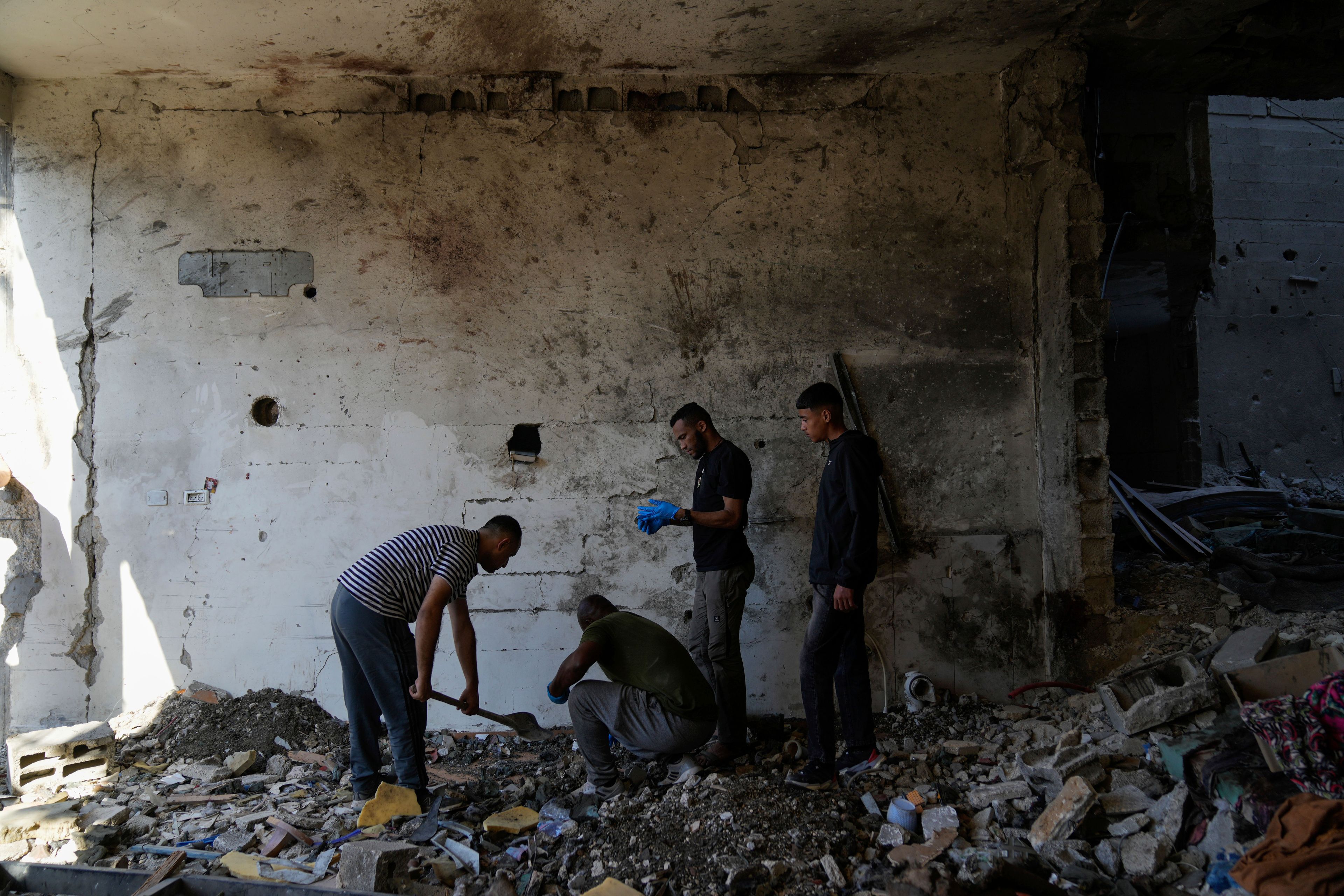 Palestinians examine the damage following an Israeli airstrike in the West Bank city of Tulkarem, which Palestinian health officials say killed 18 people and the Israeli military says took out a Hamas leader, on Friday, Oct. 4, 2024. (AP Photo/Nasser Nasser)