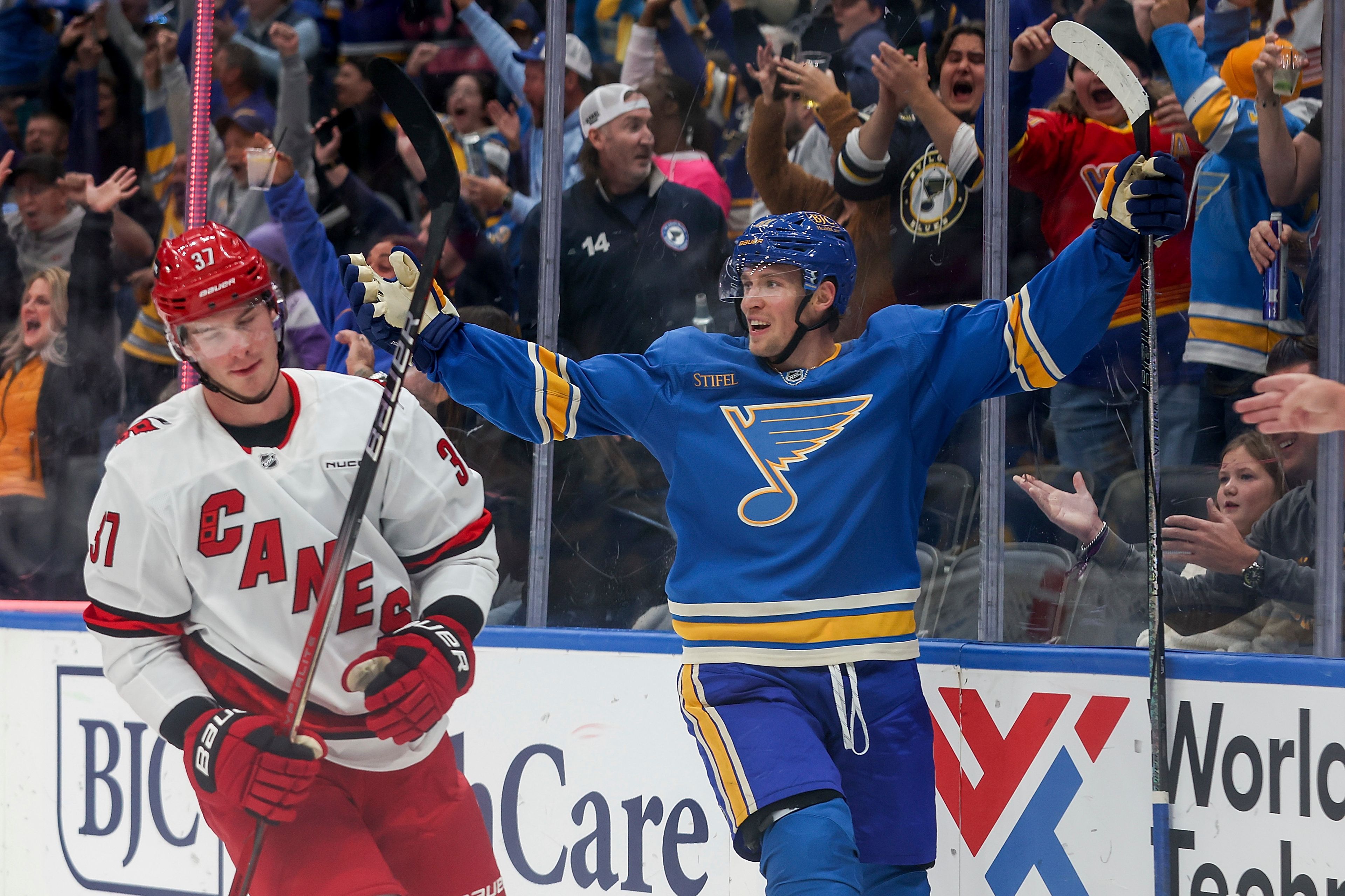 Carolina Hurricanes' Andrei Svechnikov (37) skates past St. Louis Blues' Dylan Holloway (81) as he celebrates after scoring a goal during the second period of an NHL hockey game Saturday, Oct. 19, 2024, in St. Louis. (AP Photo/Scott Kane)