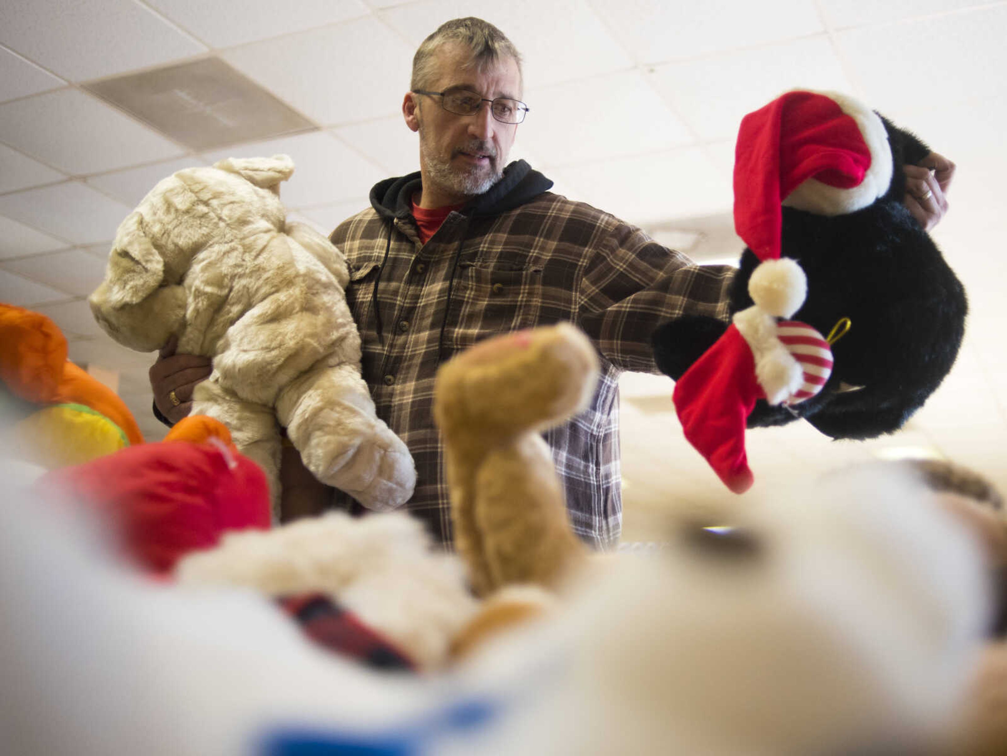 Jeff Browne picks out stuffed animals for his kids Friday, Dec. 15, 2017, at Elks Lodge #2652 in Jackson.