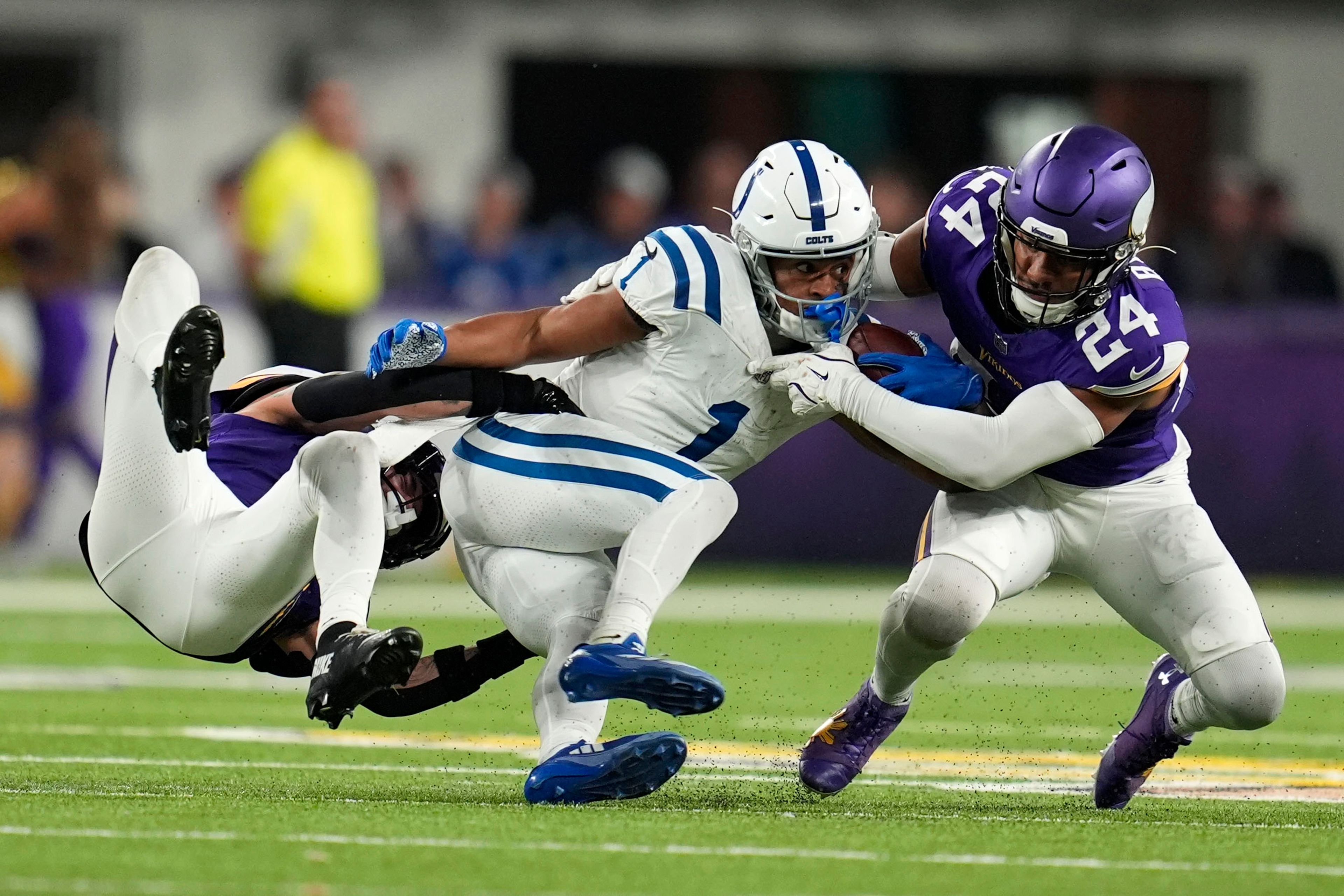 Indianapolis Colts wide receiver Josh Downs (1) is tackled by Minnesota Vikings cornerback Byron Murphy Jr., left, and safety Camryn Bynum (24) during the second half of an NFL football game, Sunday, Nov. 3, 2024, in Minneapolis. (AP Photo/Abbie Parr)