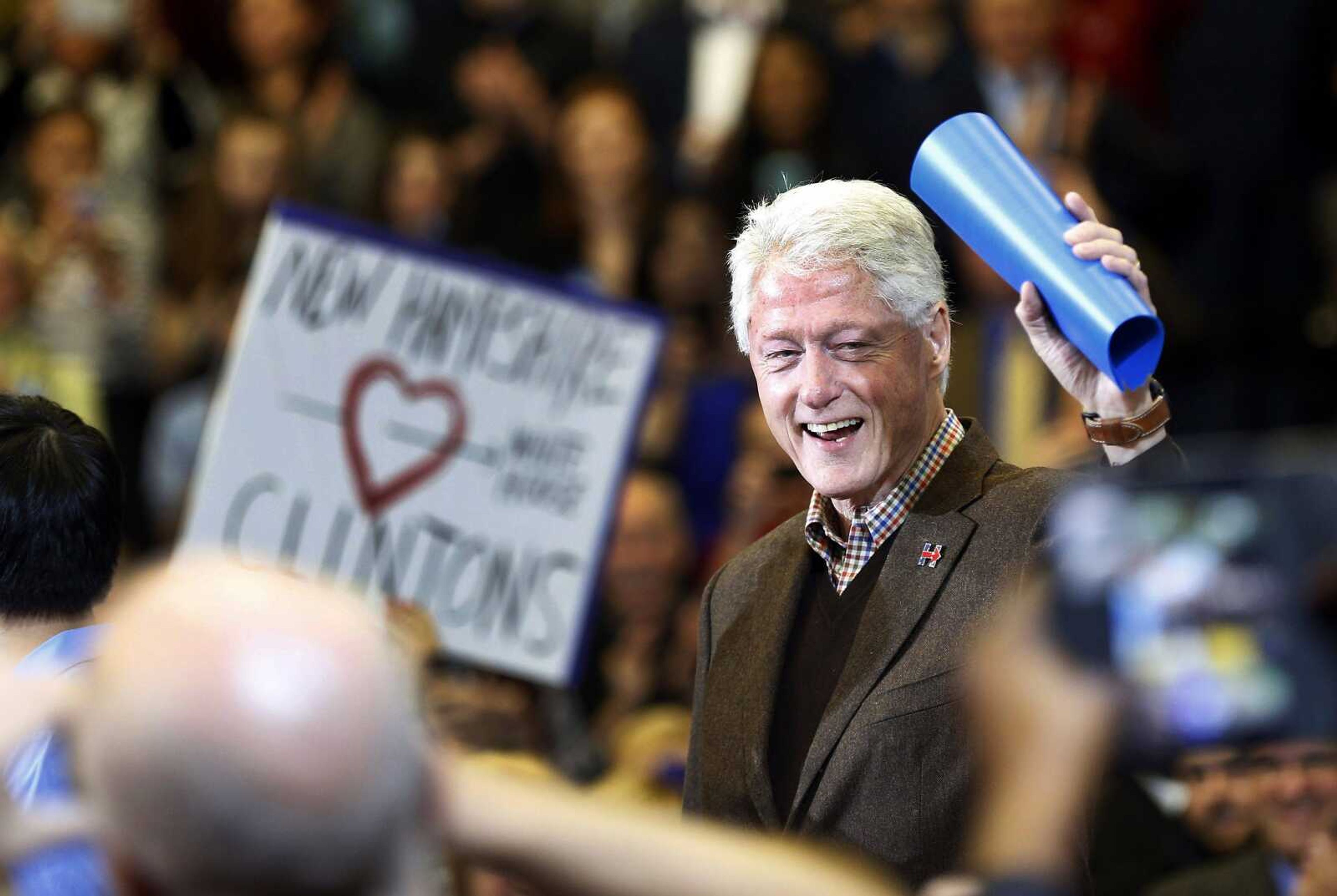 Former president Bill Clinton waves to a cheering crowd as he arrives during a campaign stop Monday for his wife, Democratic presidential candidate Hillary Clinton, in Nashua, New Hampshire. (Jim Cole ~ Associated Press)