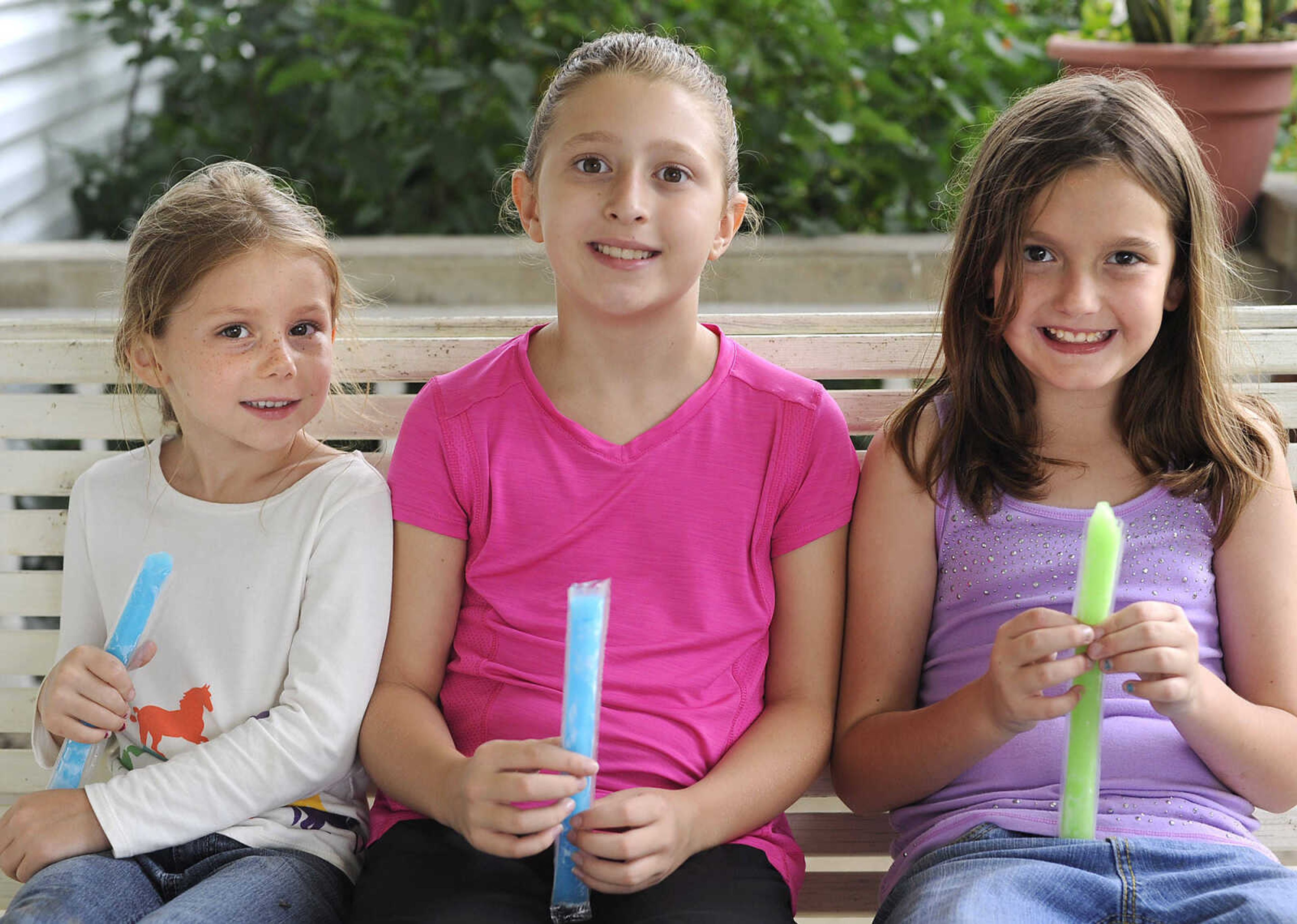 Morgan Curtis, left, Kayedy Ross and Jessica Proffer pose for a photo at a horseback riding camp Monday, July 6, 2015 at Rolling Hills Farm west of Cape Girardeau.