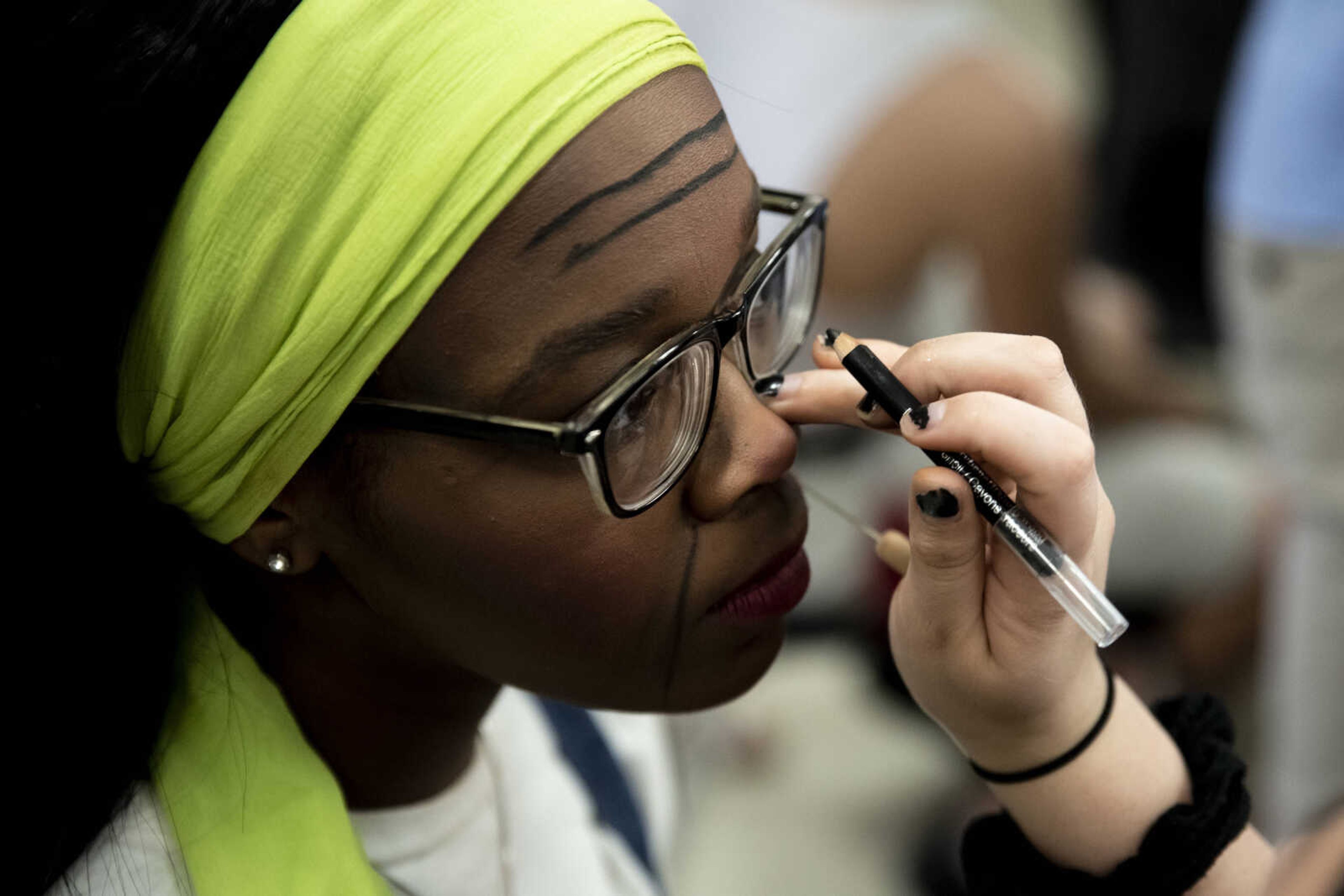 Peighton Robinson, 17, gets her character makeup adjusted by makeup head Elizabeth Hughes before going on stage and portraying the character Donna Sheridan during the Cape Central High School's spring musical production of "Mamma Mia!" Wednesday, April 10, 2019, in Cape Girardeau.