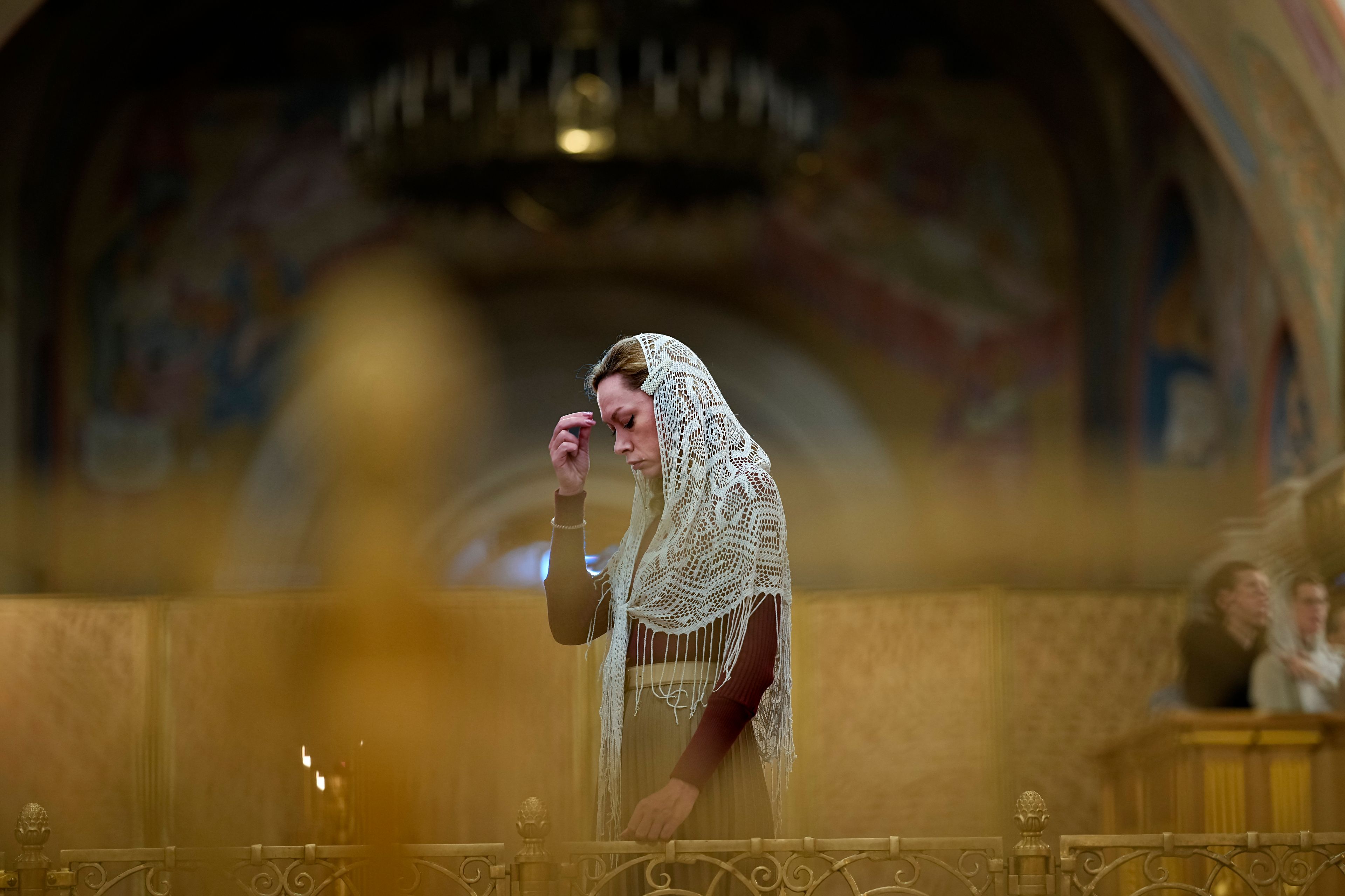 A woman crosses herself attending a memorial service that commemorates the victims of Soviet-era purges as part of 'the Day of Remembrance for the Victims of Political Repressions' at the Cathedral of Christ the Saviour in Moscow, Russia, Wednesday, Oct. 30, 2024. (AP Photo/Alexander Zemlianichenko)