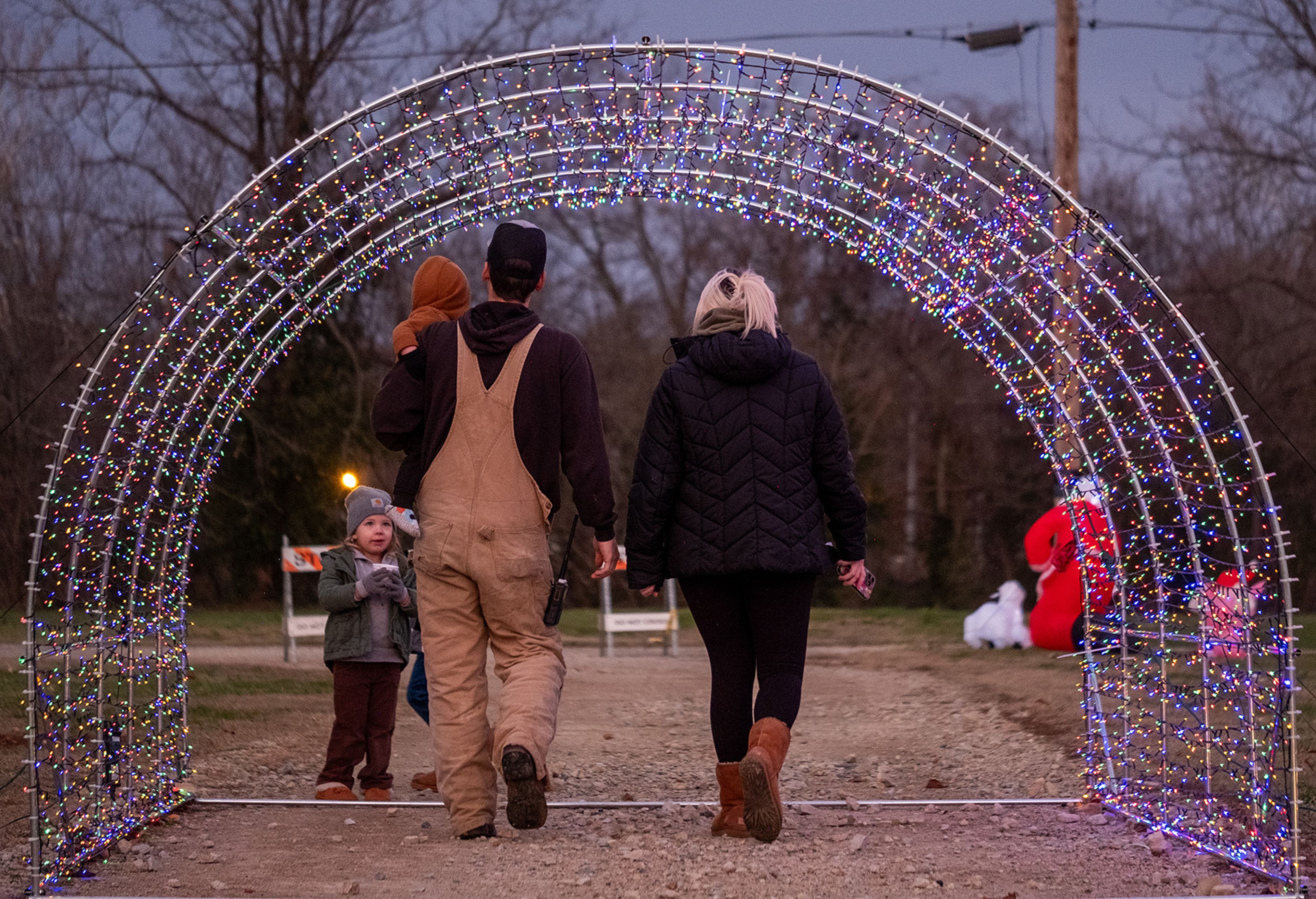 Families stroll through light displays created by members of the community.
