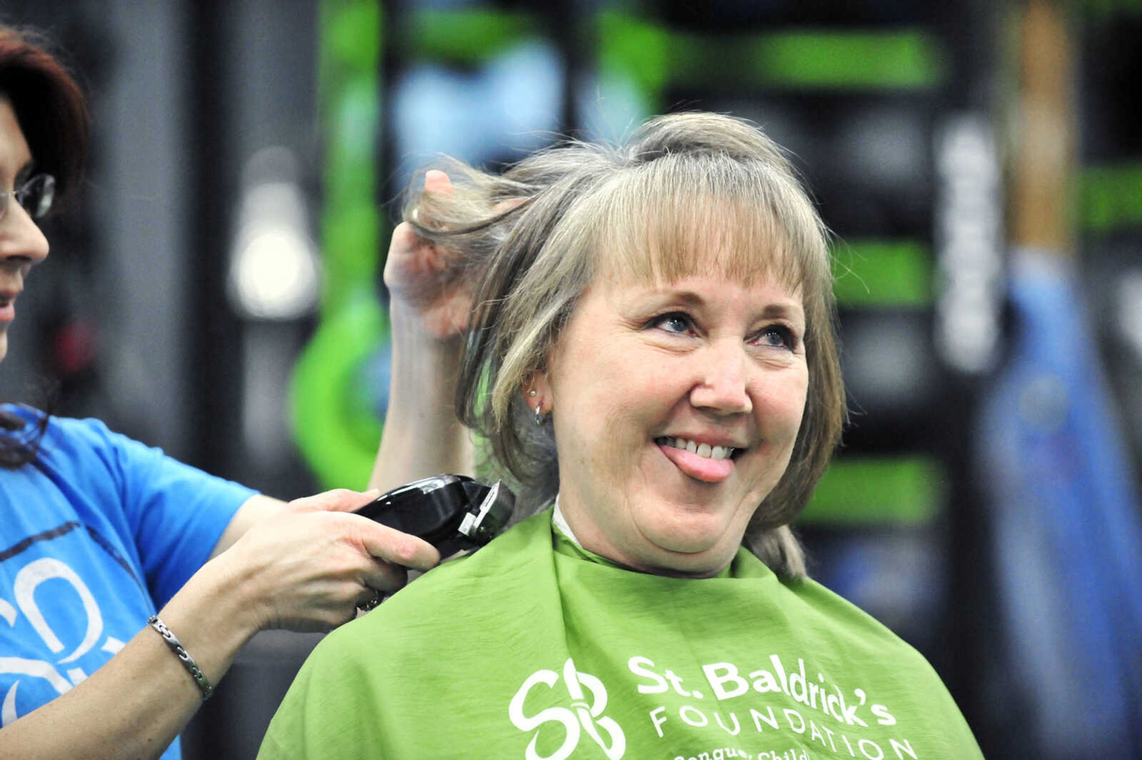 Terri Bogues reacts as April Whiteside shaves her head on Saturday, March 4, 2017, during the St. Baldrick's Foundation fundraiser at Old Orchard CrossFit in Jackson.