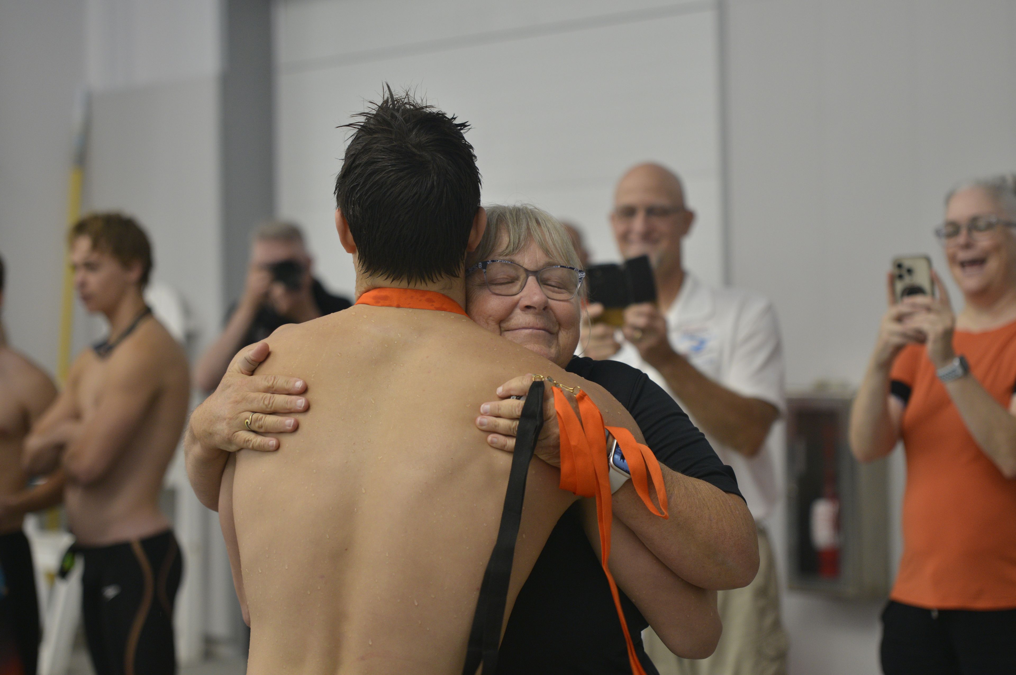 Cape Central swim coach Dayna Powell hugs senior swimmer Phineas Theall before presenting him with a first place medal at Cape Rock on Saturday, Sept. 14, at the Cape Aquatic Center.