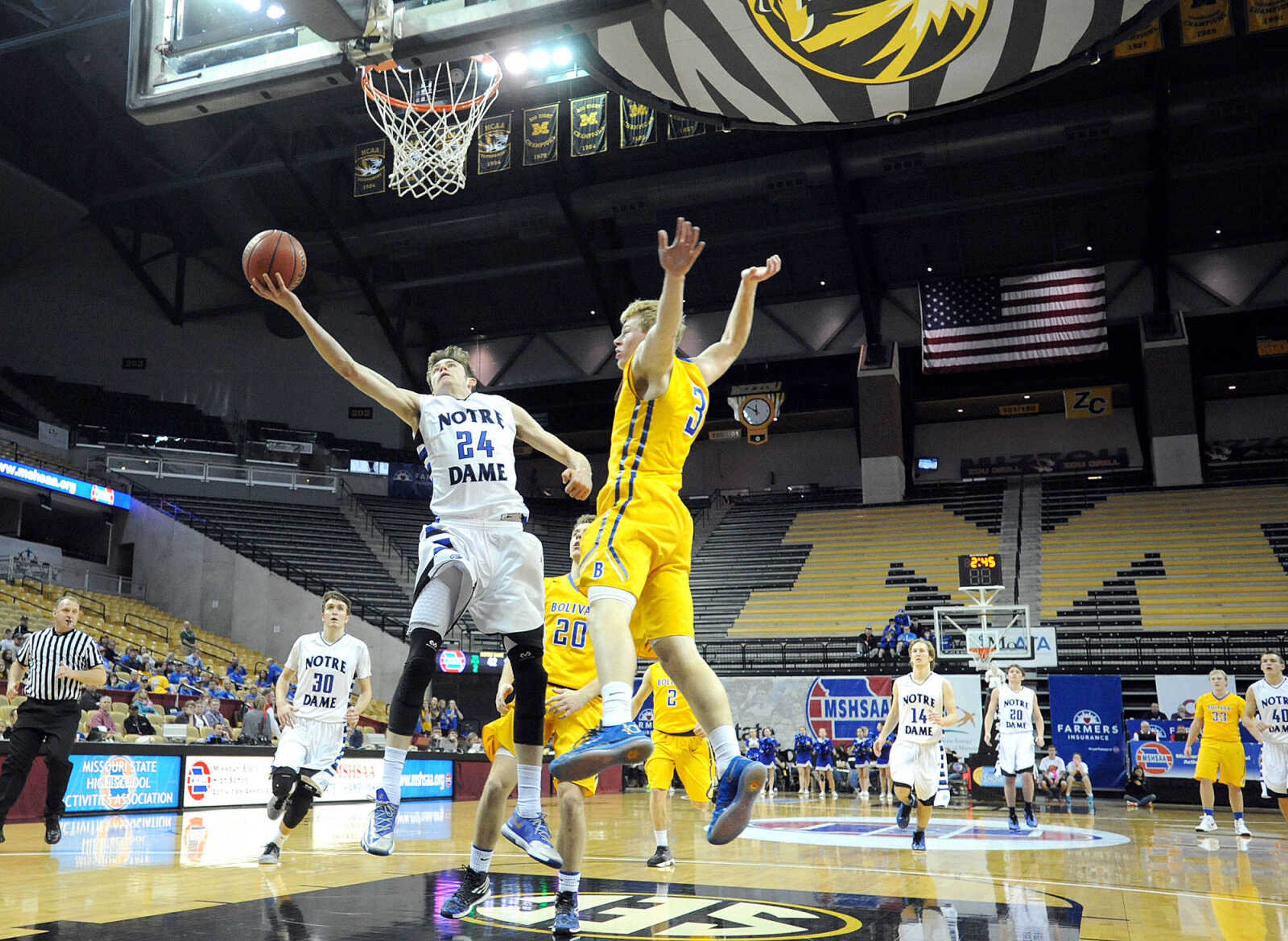 Notre Dame's Quinn Poythress sails in for a shot around Bolivar's Johnny Scott in the third quarter of the Bulldogs Class 4 third-place game against the Liberators, Friday, March 20, 2015, in Columbia, Missouri. Notre Dame won 65-44. (Laura Simon)