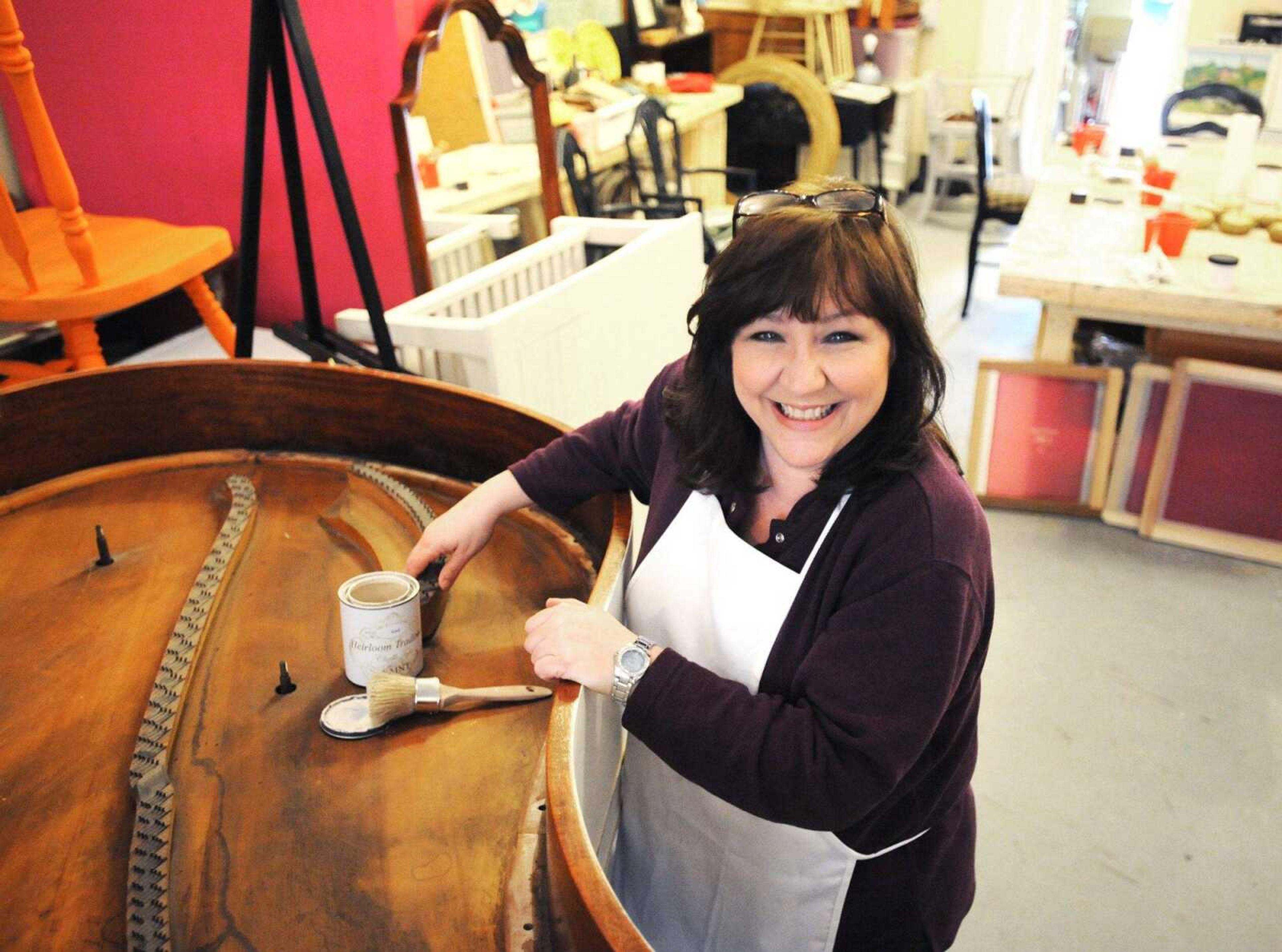 Susan Hall stands next to an old piano she is repurposing for a client at Shoppe La La in Cape Girardeau. (Laura Simon)