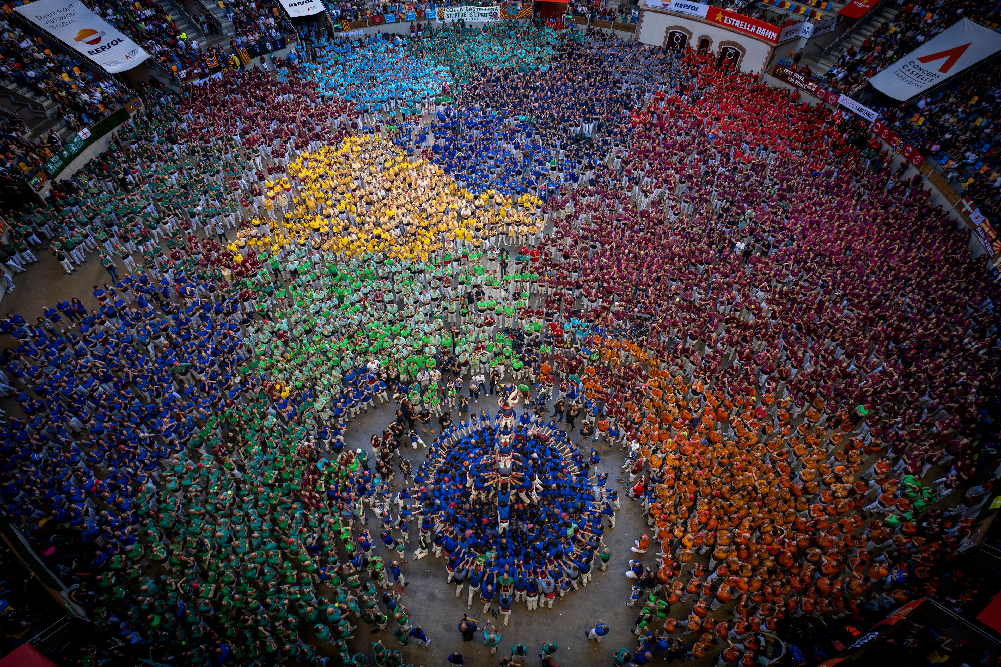 Members of "Castellers de la Vila de Gracia" complete their "Castell" during the 29th Human Tower Competition in Tarragona, Spain, Saturday, Oct. 5, 2024. (AP Photo/Emilio Morenatti)