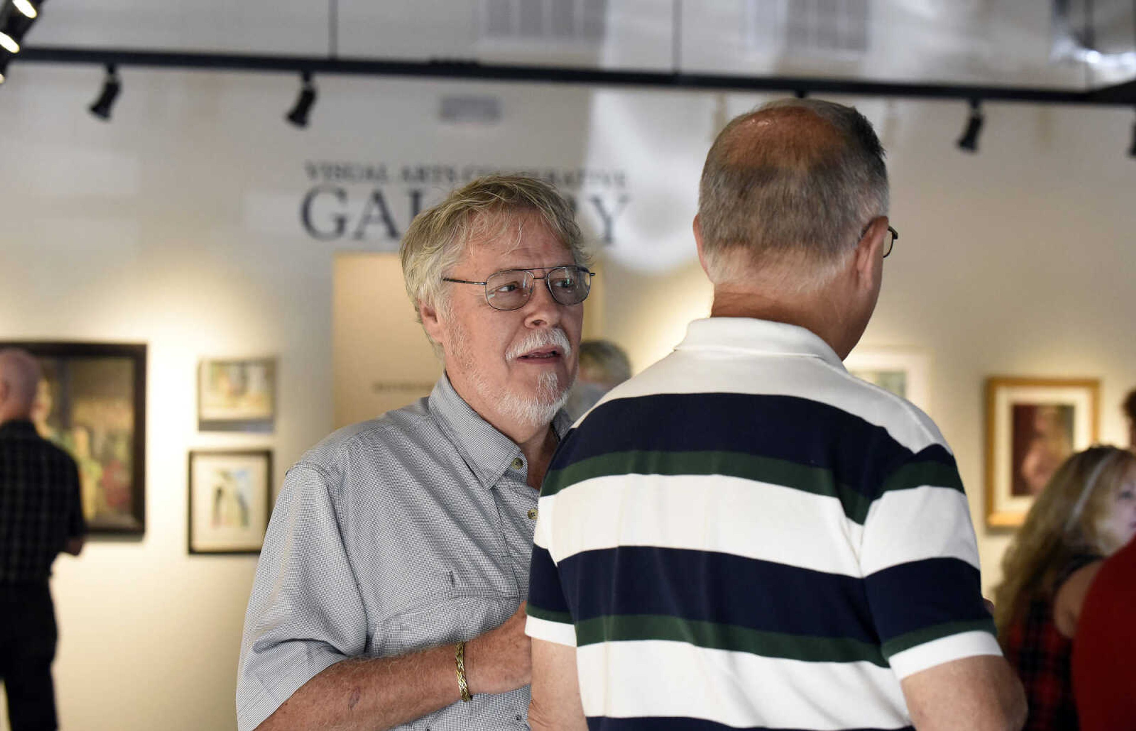 LAURA SIMON ~ lsimon@semissourian.com

Don Greenwood visits with visitors to the grand opening reception for the 4th annual Members Exhibit at the Arts Council of Southeast Missouri in its new location at 16 North Spanish Street in downtown Cape Girardeau on Friday, Sept. 2, 2016.