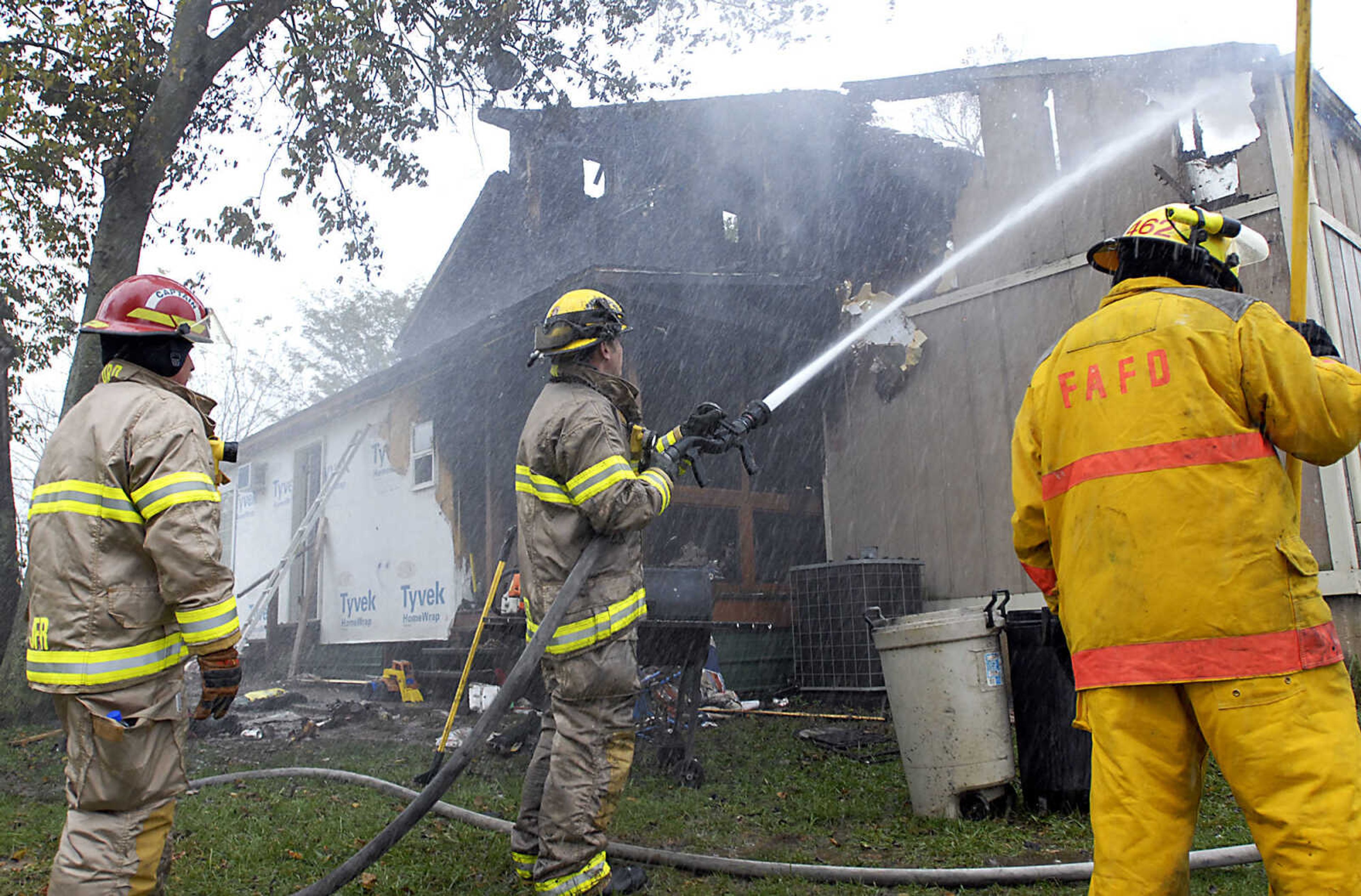 KIT DOYLE ~ kdoyle@semissourian.com
Jackson Fire and Rescue's Andrew Juden sprays the northeast corner of the Ladd home on Big Cone Lane Friday, October 16, 2009, north of Jackson.