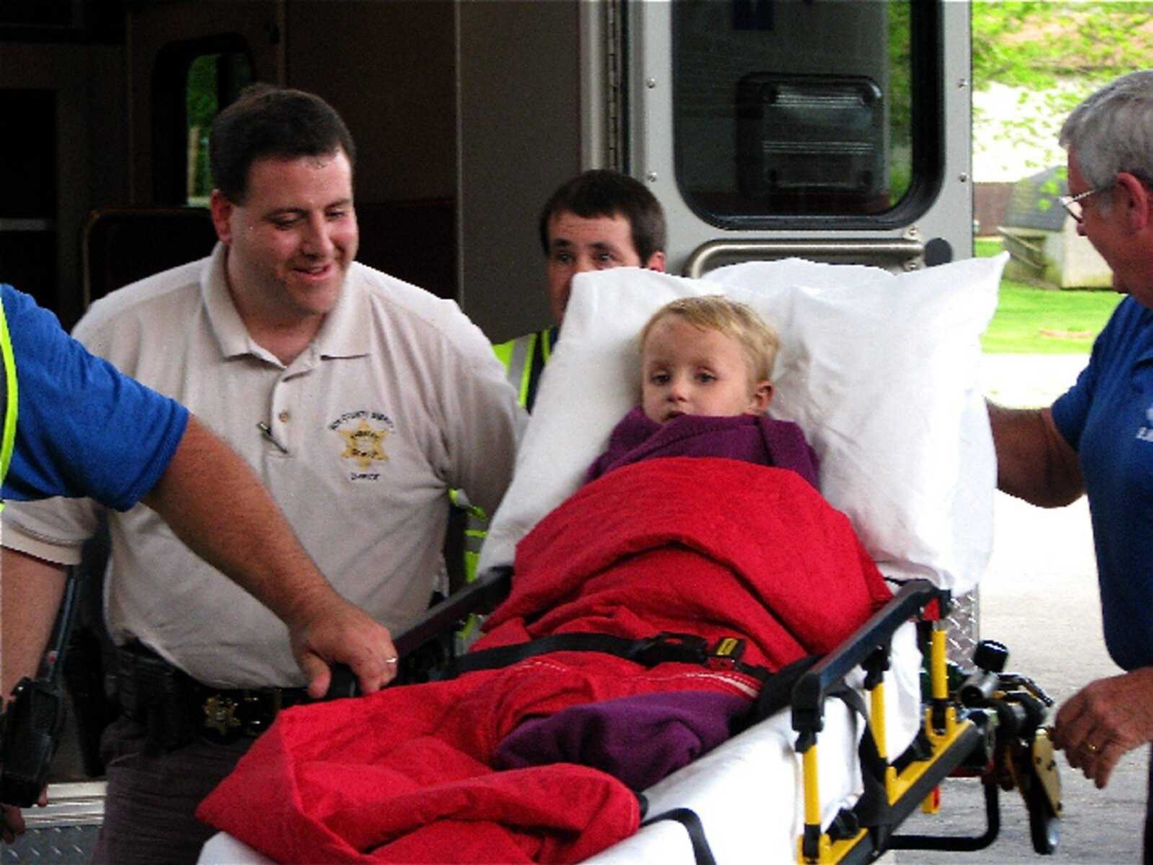 Joshua Childers, the 3-year-old boy who slipped out of his family's mobile home near Arcadia, Mo., in rural southeast Missouri on Monday, is loaded into the back of an ambulance after he was found about three miles from his home Wednesday, May 6, 2009, in Arcadia, Mo. The child was evaluated and listed in fair condition, first at Iron County Hospital and later at Jefferson Regional Medical Center in Crystal City, where he was transferred because it has a larger pediatric unit. (AP Photo/Mountain Echo News, Kevin Jenkins)