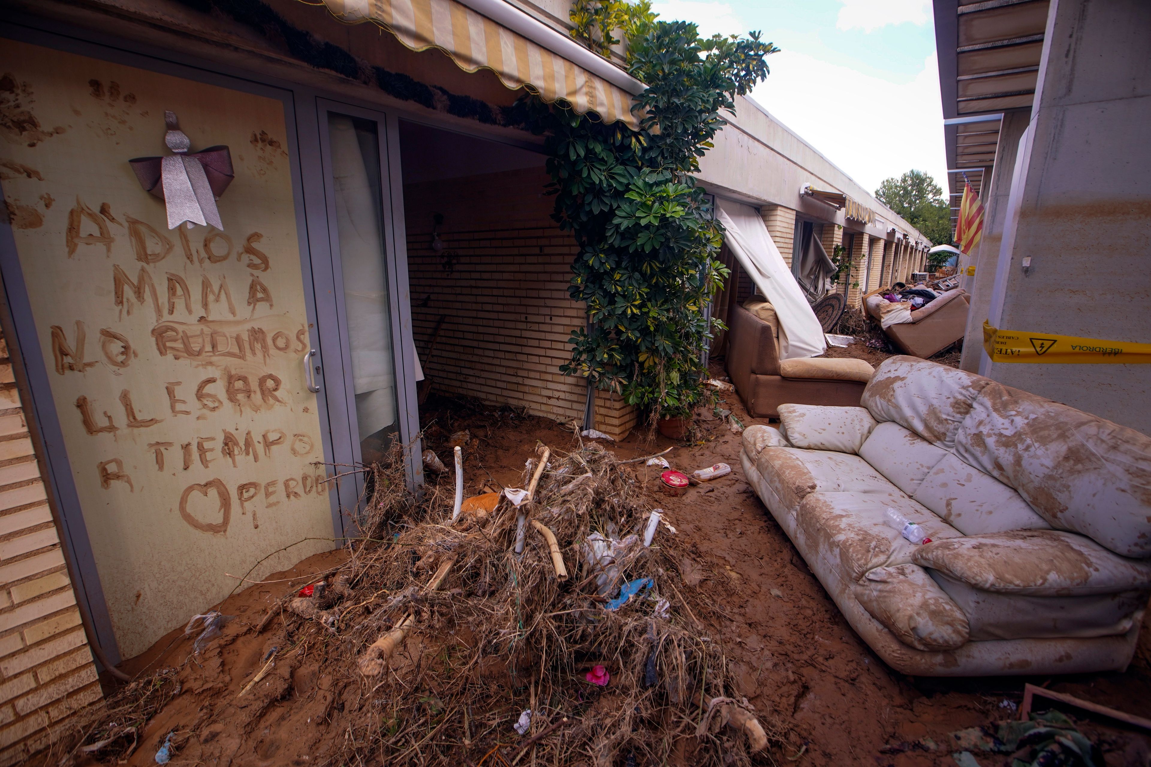 Writing on a wall of a centre for pensioners reads 'Goodbye mum. We didn't arrive on time. Sorry' after floods in Picanya on the outskirts of Valencia, Spain, Thursday, Nov. 7, 2024. (AP Photo/Alberto Saiz)