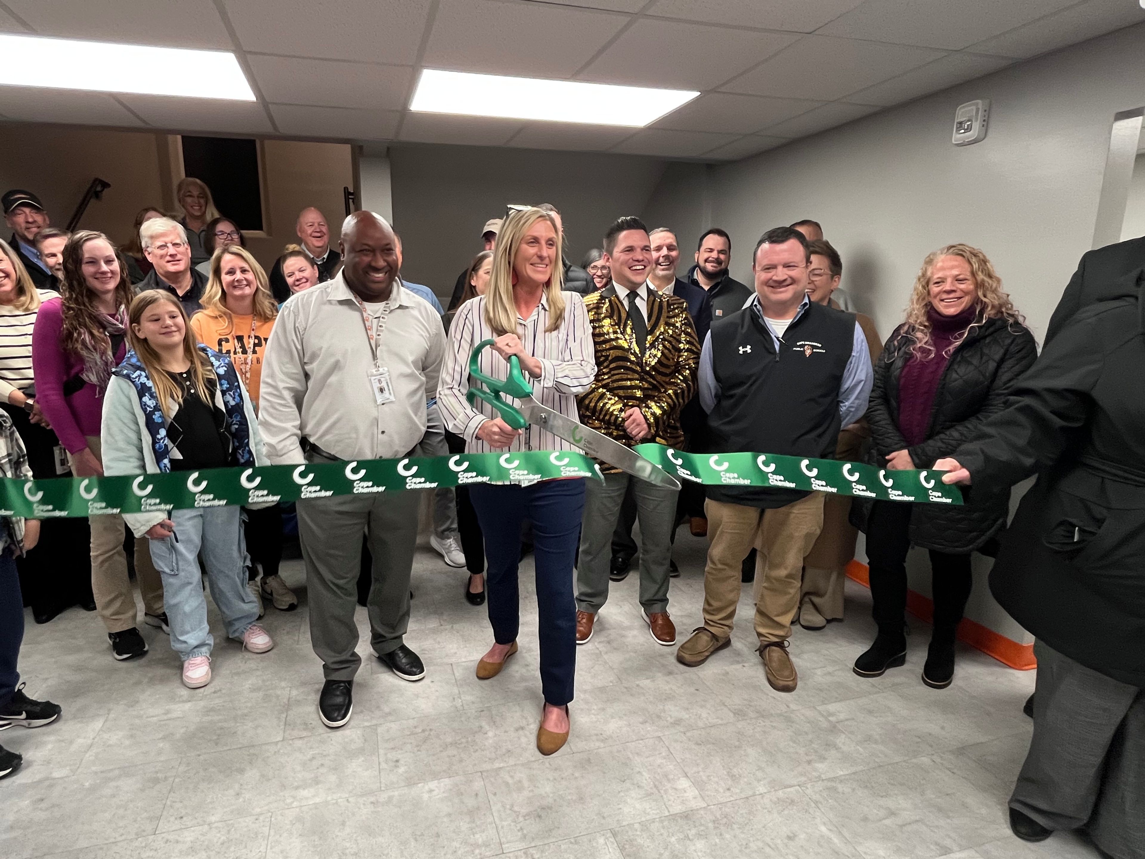 Cape Central Academy director Andrea Beggs cuts the ribbon during a ceremony Tuesday, Dec. 3, at Cape Central Academy. 