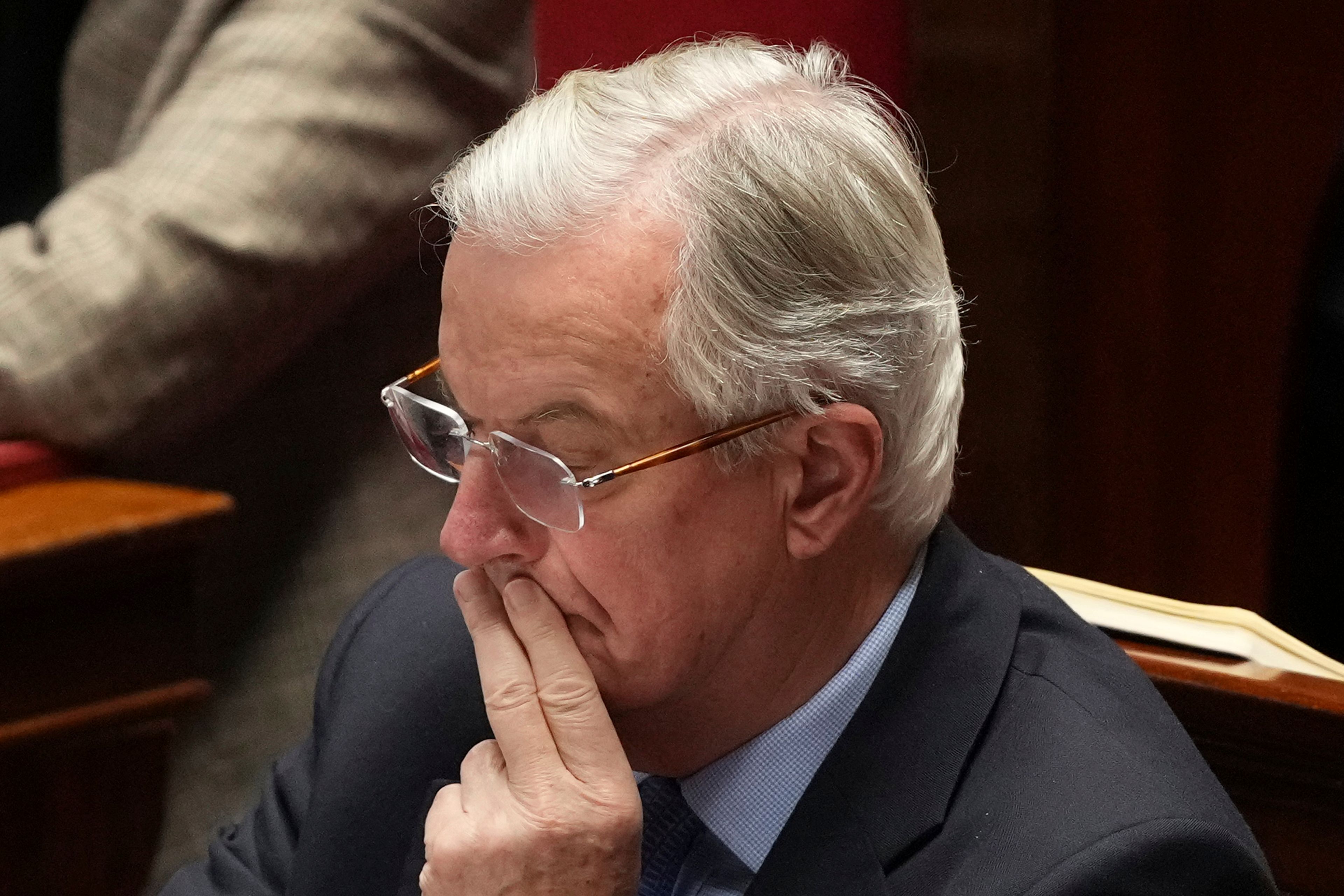 French Prime Minister Michel Barnier listens to speeches at the National Assembly prior to a no-confidence vote that could bring down the Prime Minister and the government for the first time since 1962, Wednesday, Dec. 4, 2024 in Paris. (AP Photo/Michel Euler)