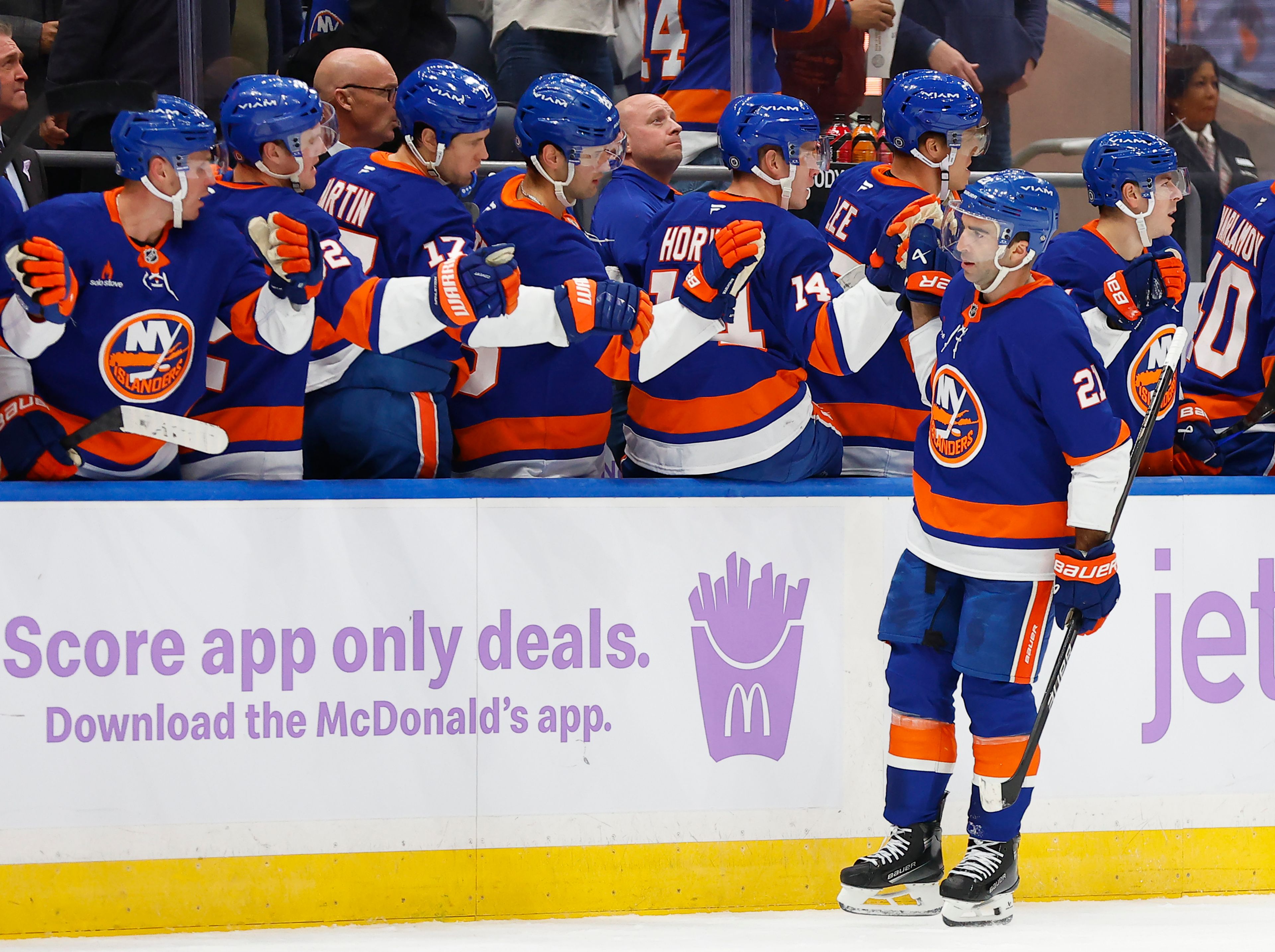 New York Islanders center Kyle Palmieri (21) celebrates with teammates after scoring a goal against the St. Louis Blues head coach Steve Ott () during the first period of an NHL hockey game, Saturday, Nov. 23, 2024, in New York. (AP Photo/Noah K. Murray)