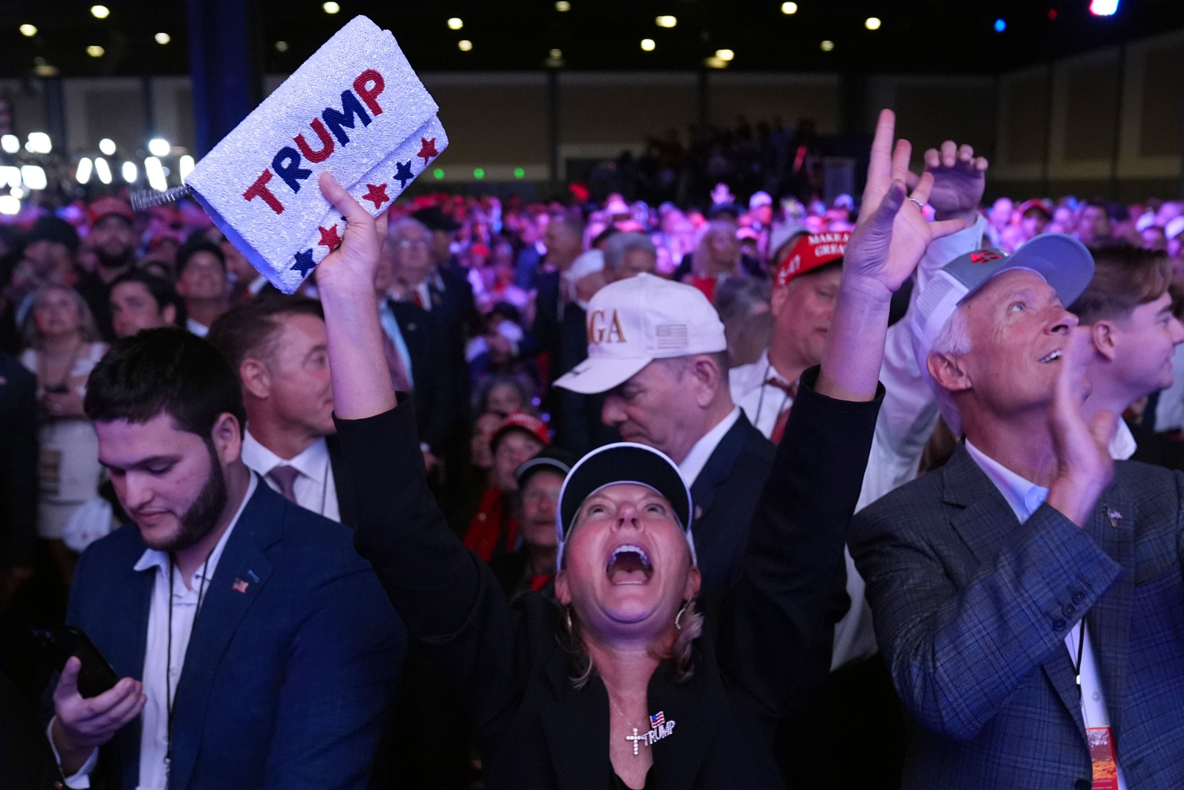 Supporters watch returns at a campaign election night watch party for Republican presidential nominee former President Donald Trump at the Palm Beach Convention Center, Wednesday, Nov. 6, 2024, in West Palm Beach, Fla. (AP Photo/Evan Vucci)