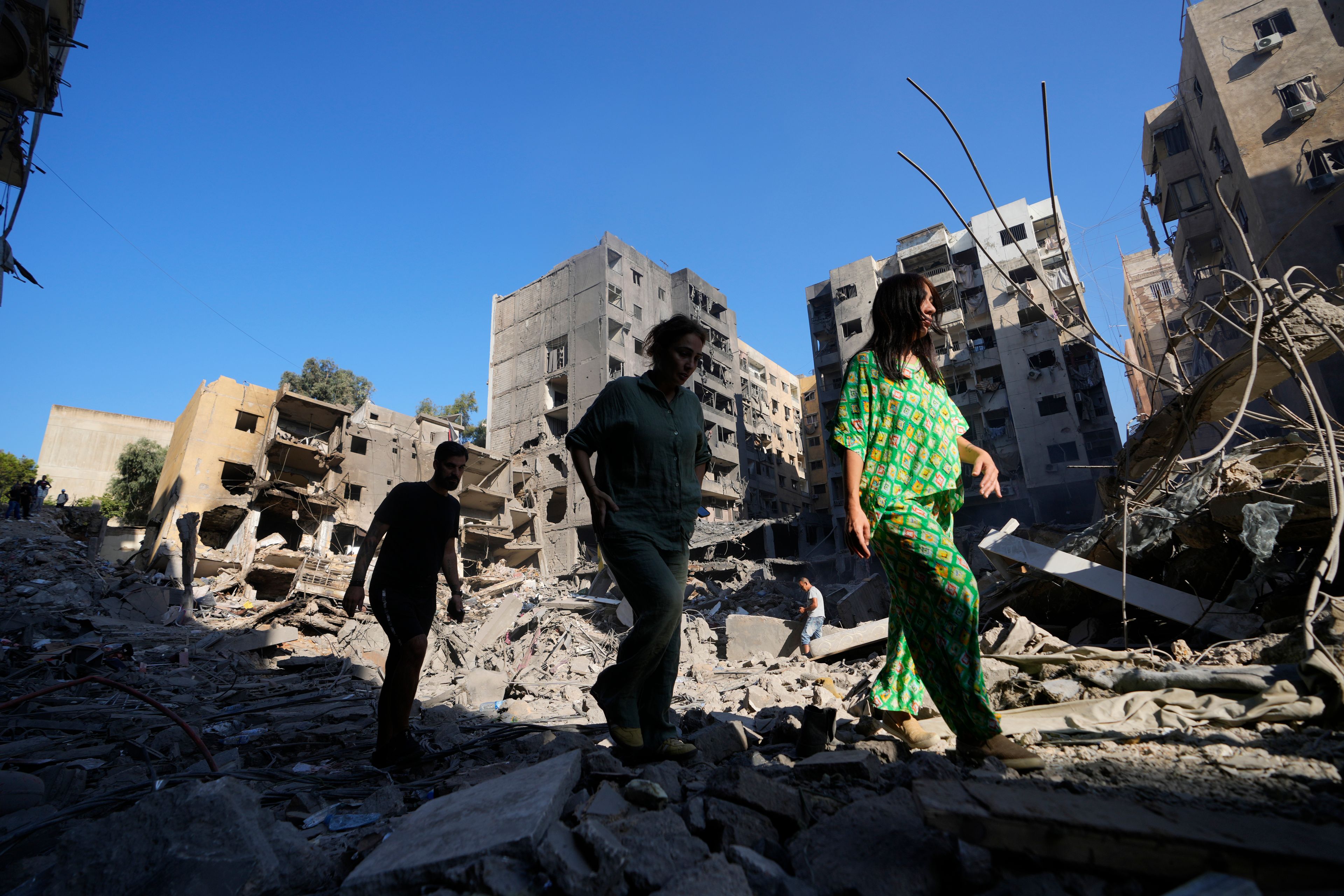 People check the site of the assassination of Hezbollah leader Hassan Nasrallah in Beirut's southern suburbs, Sunday, Sept. 29, 2024. (AP Photo/Hassan Ammar)