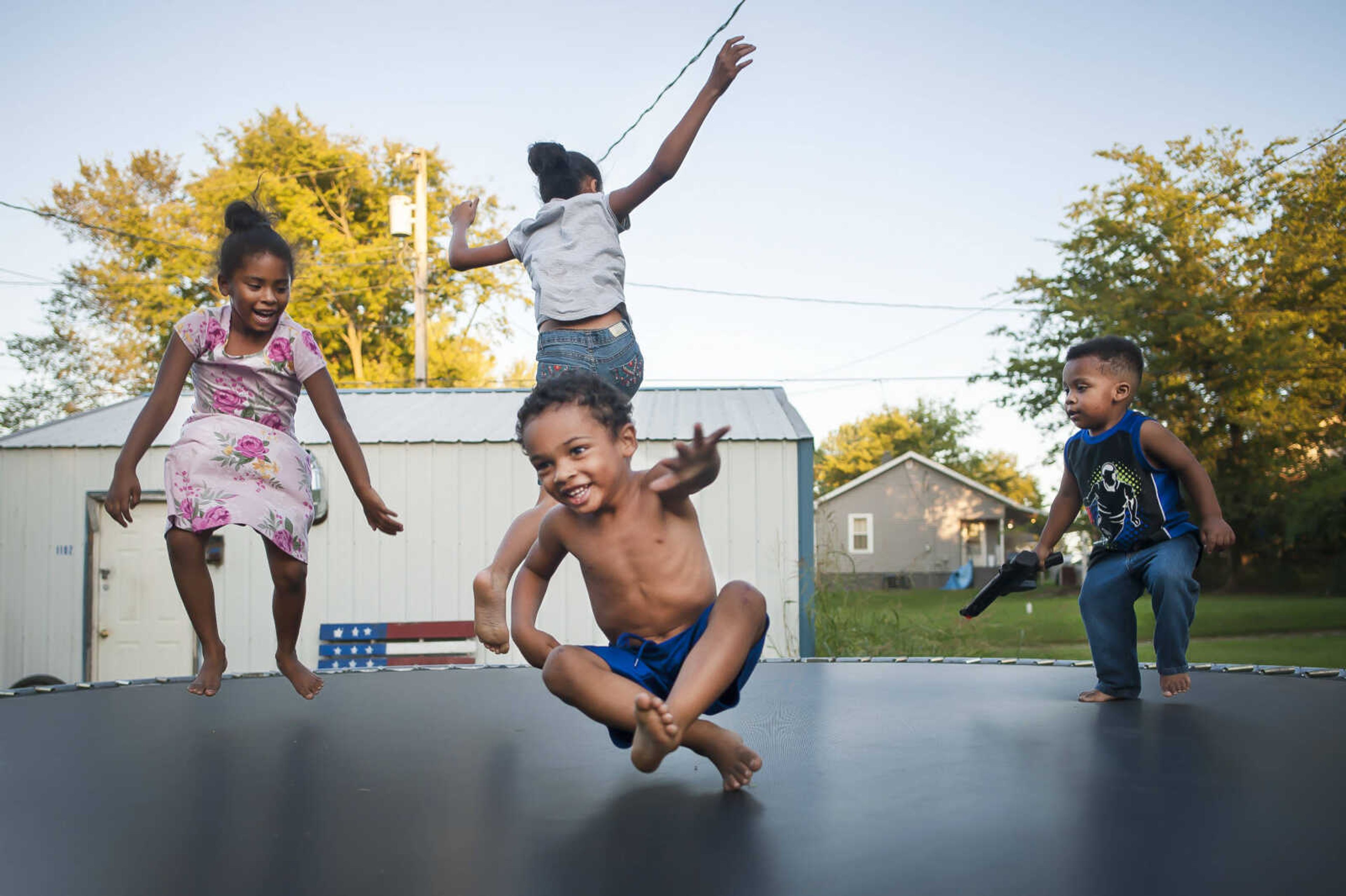 Clockwise from left, Amya Patterson, 5, Justis Howell, 10, and Deandre Abraham, 2, bounce A'shon Howell, 3, below center, on a trampoline Thursday, Oct. 3, 2019, in Cape Girardeau.