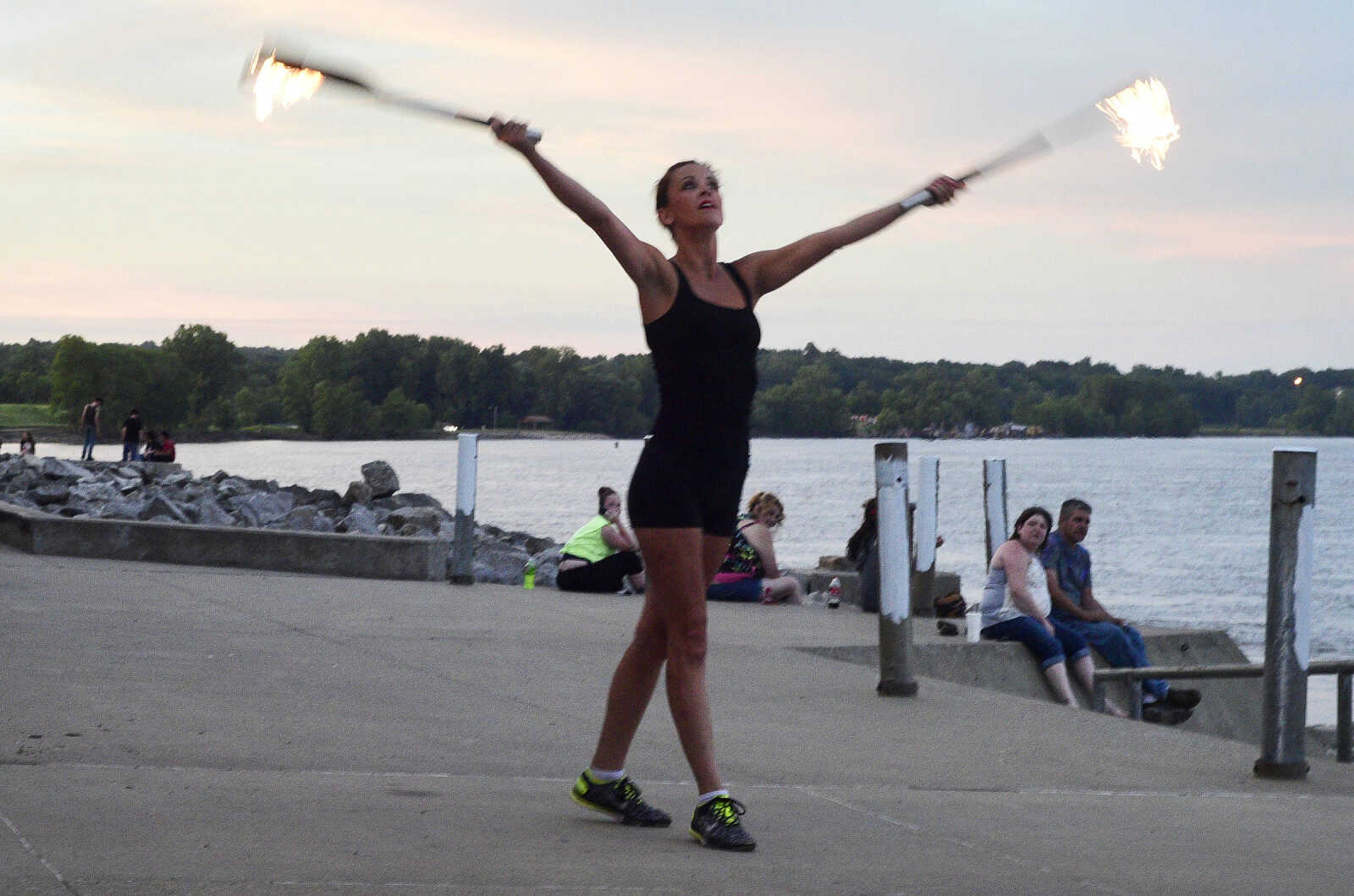 Erin Fluegge twirls flaming knives along the riverfront on Friday, June 16, 2017, in downtown Cape Girardeau.