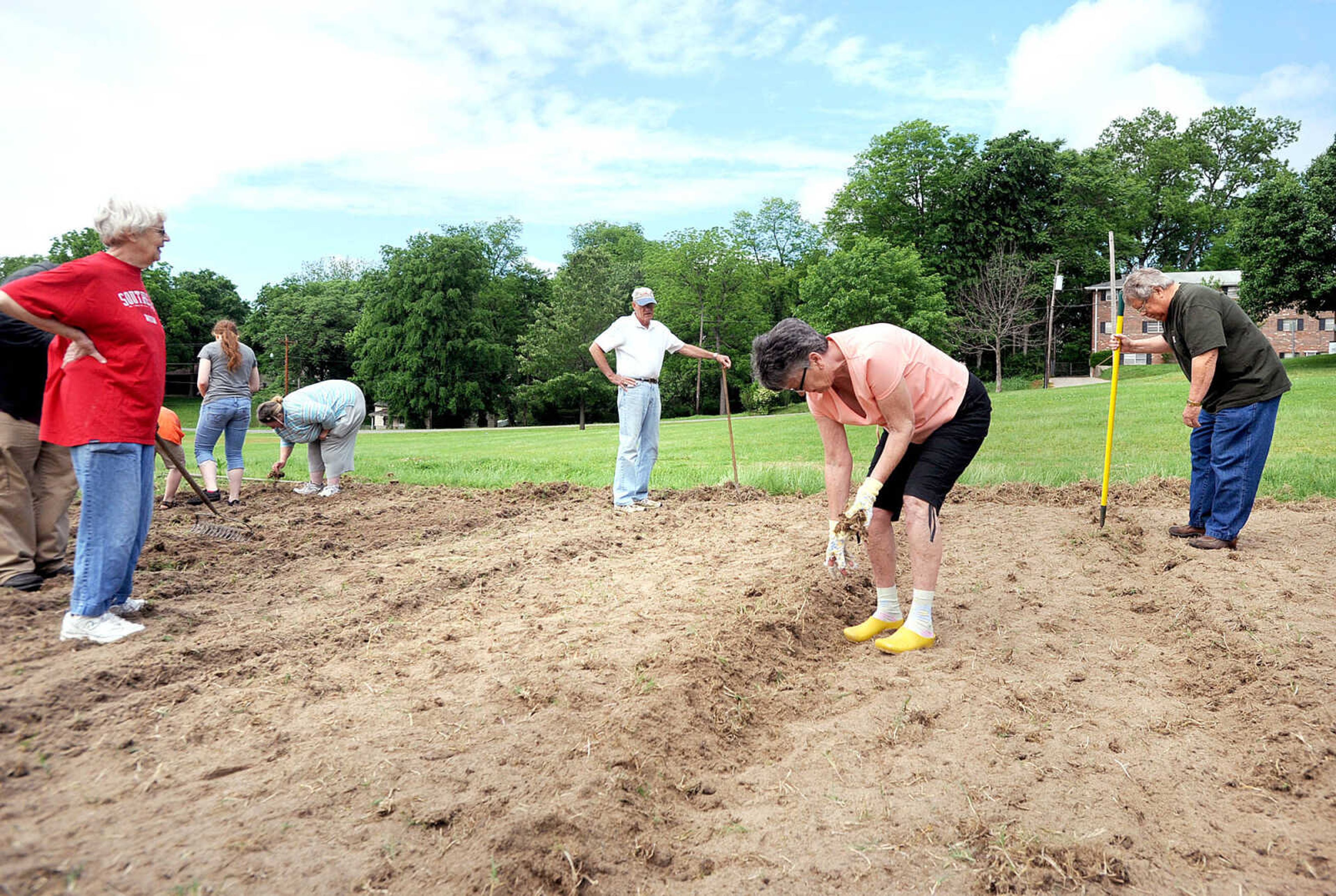 LAURA SIMON ~ lsimon@semissourian.com

From left, Joan Jones, Bill and Marian Green and Gerald Jones work in the new community garden in Washington Park, Wednesday, May 22, 2013 in Cape Girardeau. The garden has two rows each of deer resistant okra, yellow squash and cucumbers.