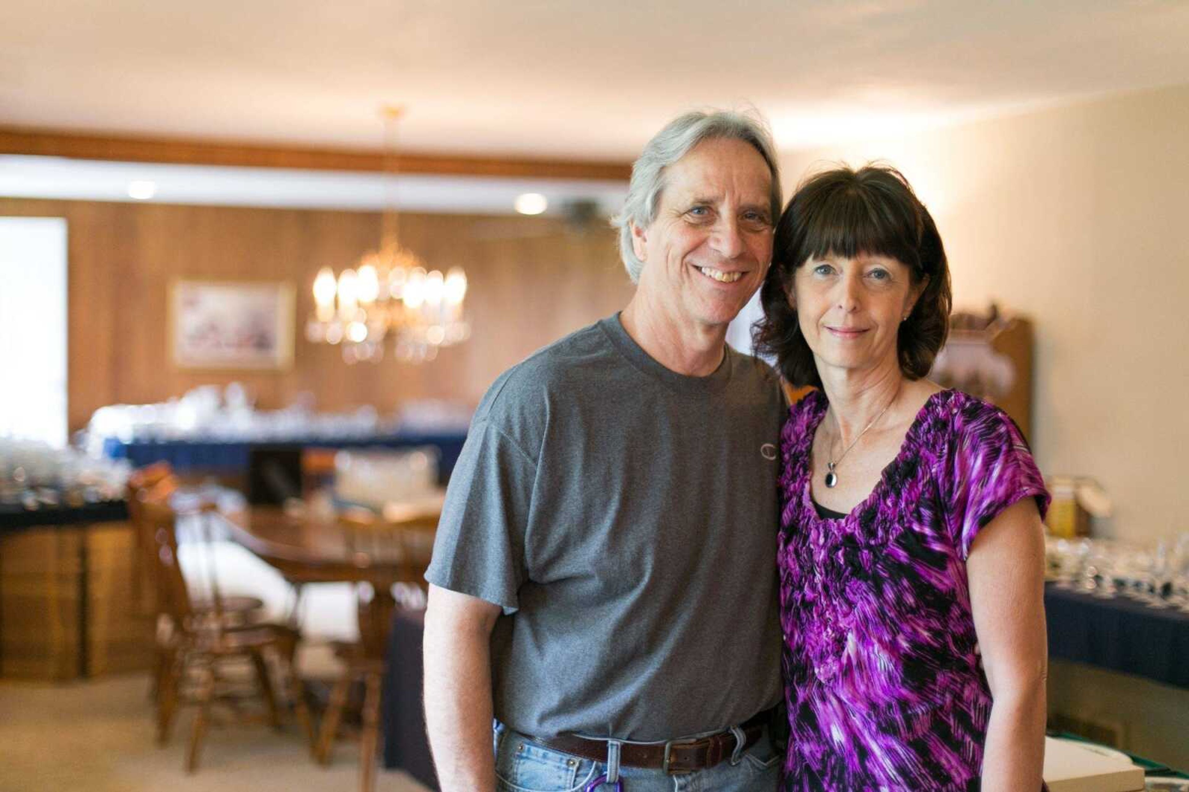 Tracy and Debbie Childers take a break from helping customers to pose for a photo at an estate sale they hosted May 16 in Cape Girardeau. (Glenn Landberg)