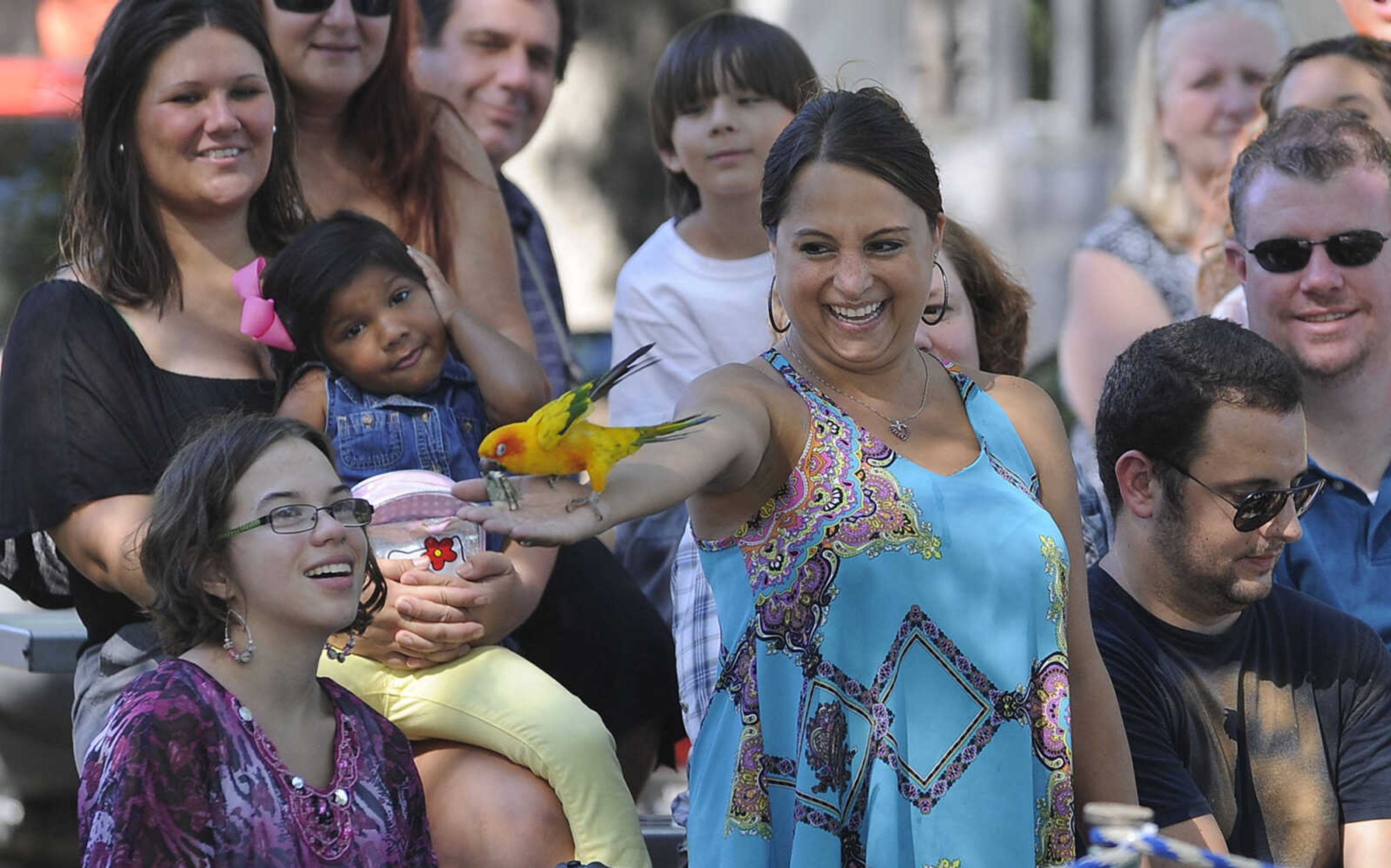 FRED LYNCH ~ flynch@semissourian.com
As Tricia Roth of Cape Girardeau stretches out her arm, Chico the sun conure returns the dollar bill he had snatched from her during a performance of "Wild About Monkeys" on Sunday, Sept. 7, 2014 at the SEMO District Fair.