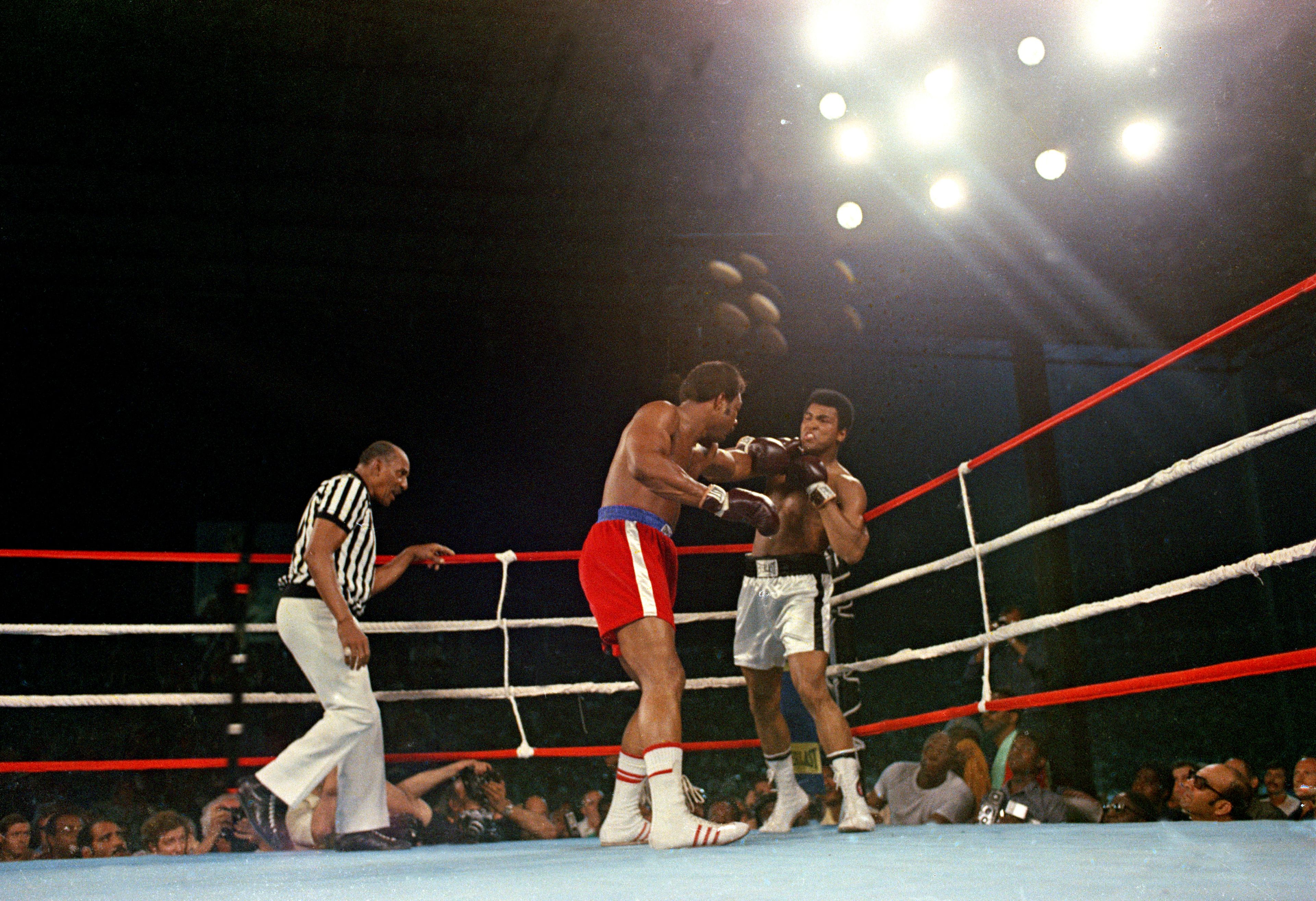 FILE - Challenger Muhammad Ali is hit with a left jab by defending world champion George Foreman during the WBA/WBC championship bout in Kinshasa, Zaire, on Oct. 30, 1974. (AP Photo, File)