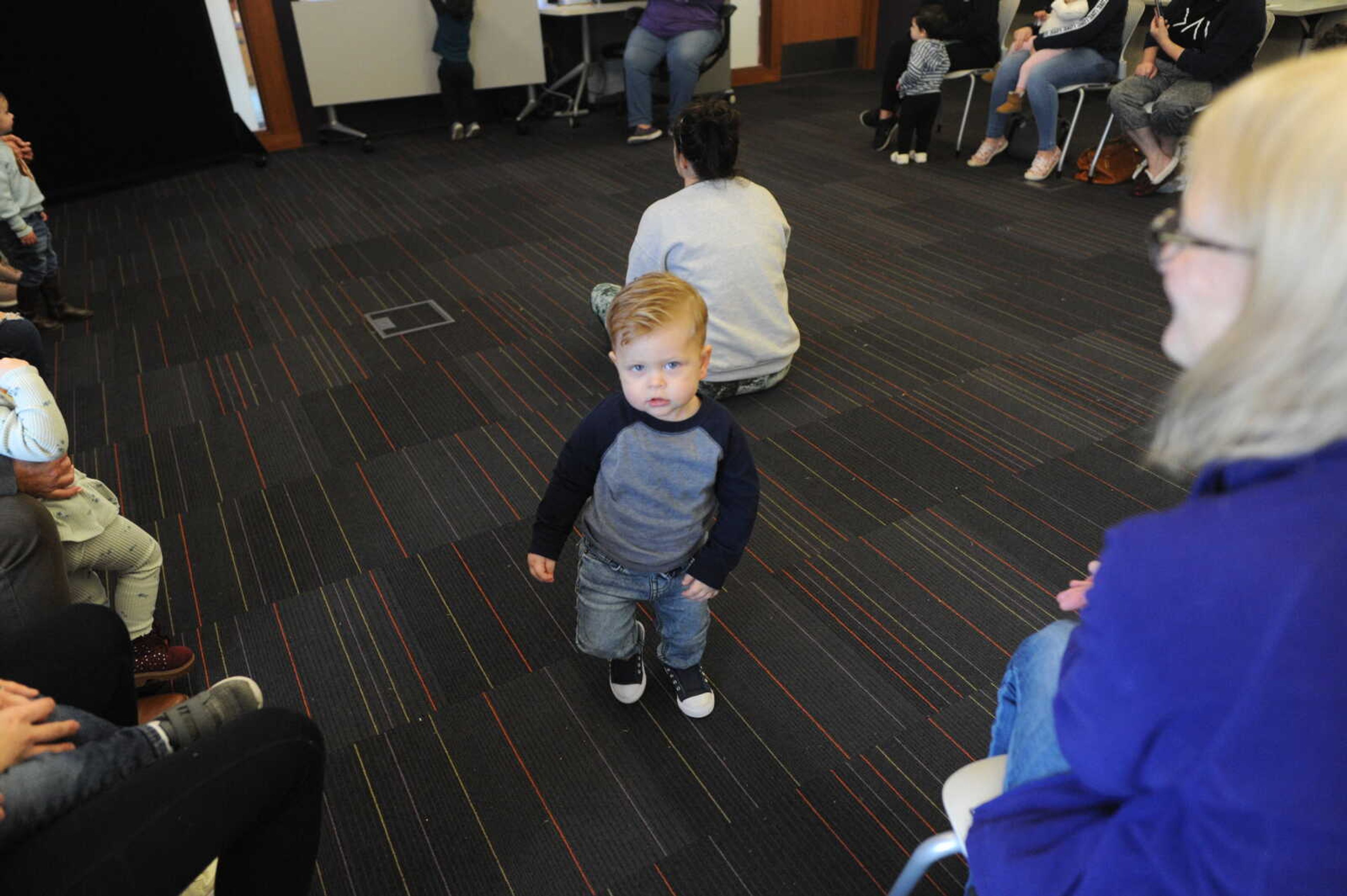 Dakota Villagrana stomps his feet to the music during Toddler Time.