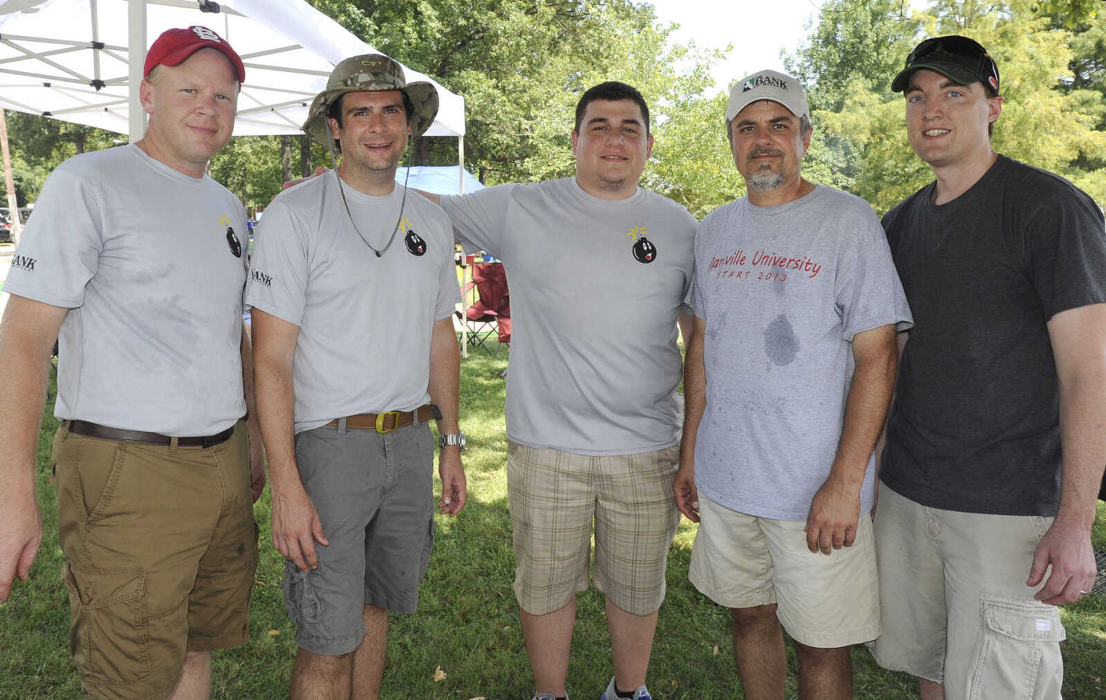 Eric Clements, left, L.A. Dauer, Tyler Burk, Wendell Mueller and Ben Brinkman with The Bank of Missouri BBQ Team pose for a photo Saturday, Aug. 23, 2014 at the Cape BBQ Fest in Arena Park.